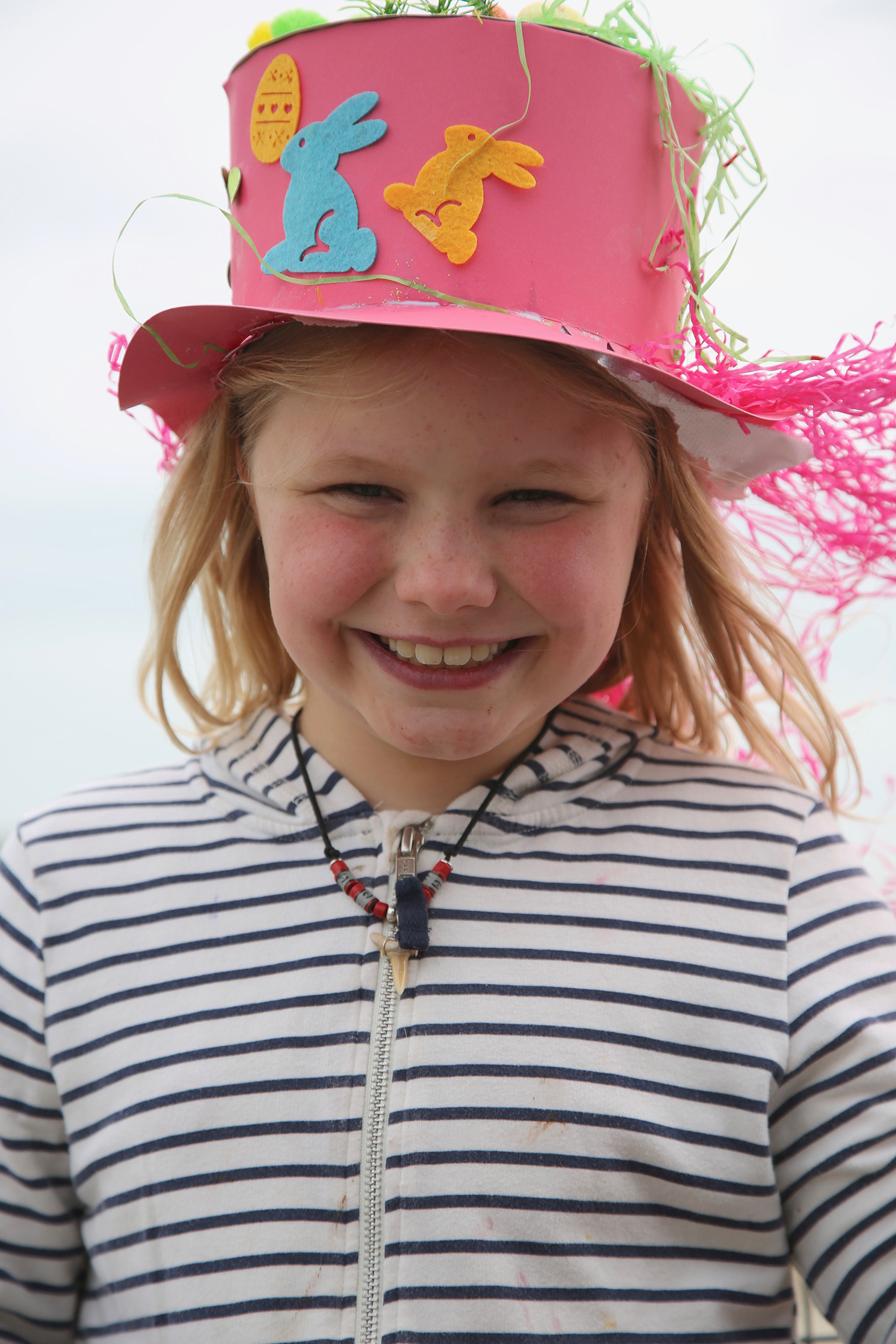 A smiling Annie proudly wears her competition-winning Easter bonnet