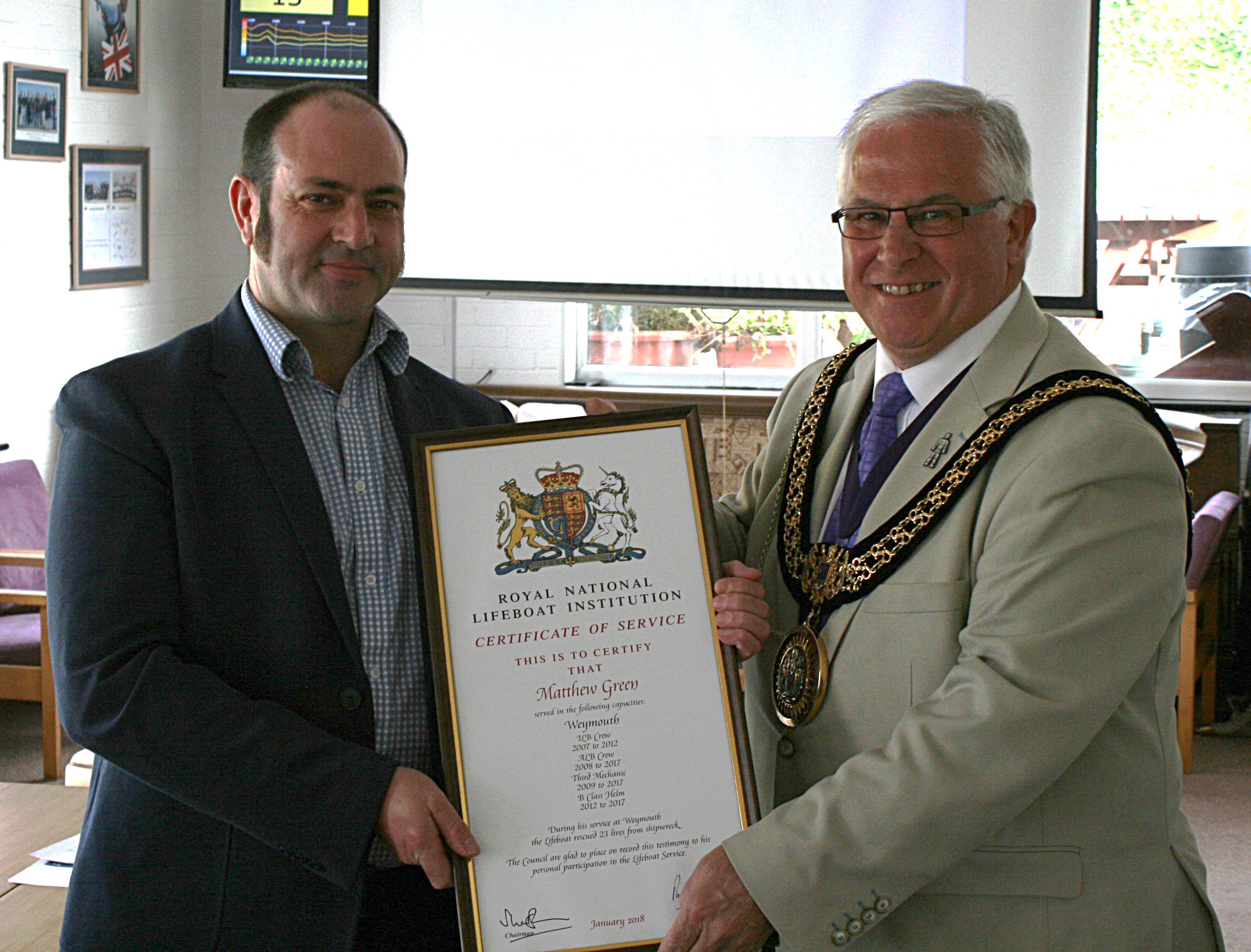 Matt Green recieves his certificate from the Mayor
