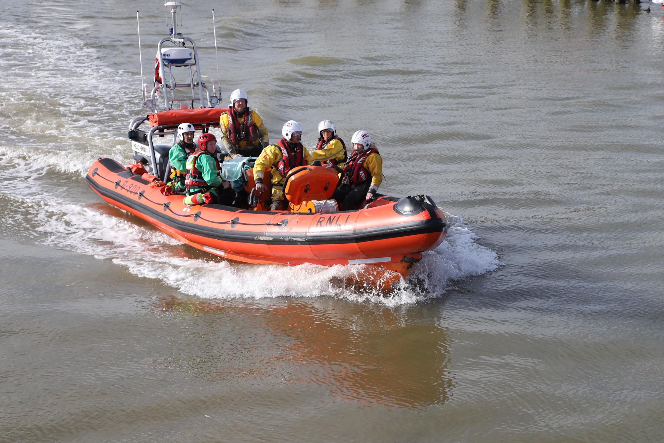 The lifeboat and its crew returning to the station with the casualty on board
