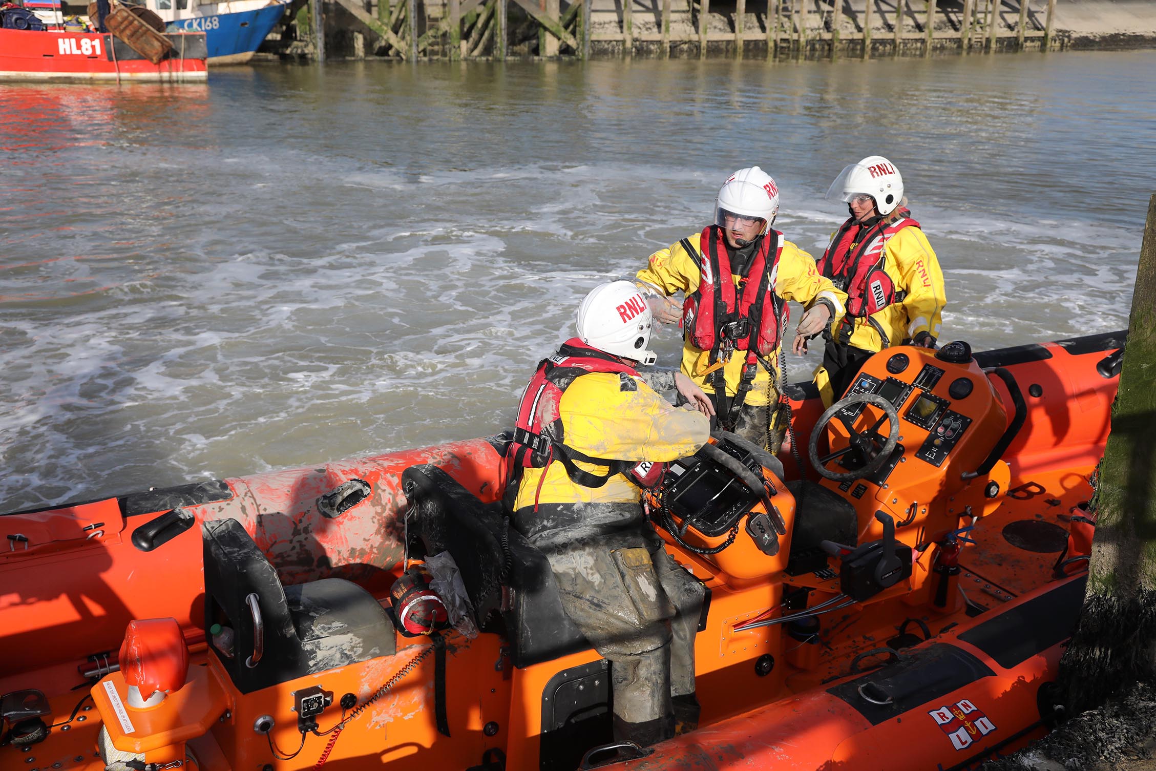 The lifeboat moored back at the station with the crew discussing the rescue 