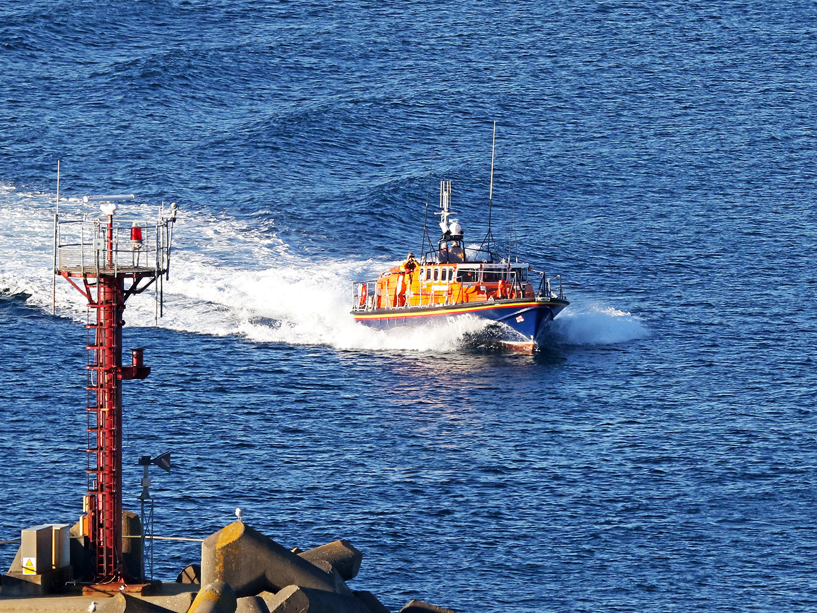 Douglas lifeboat Sir William Hillary passing Douglas harbour entrance