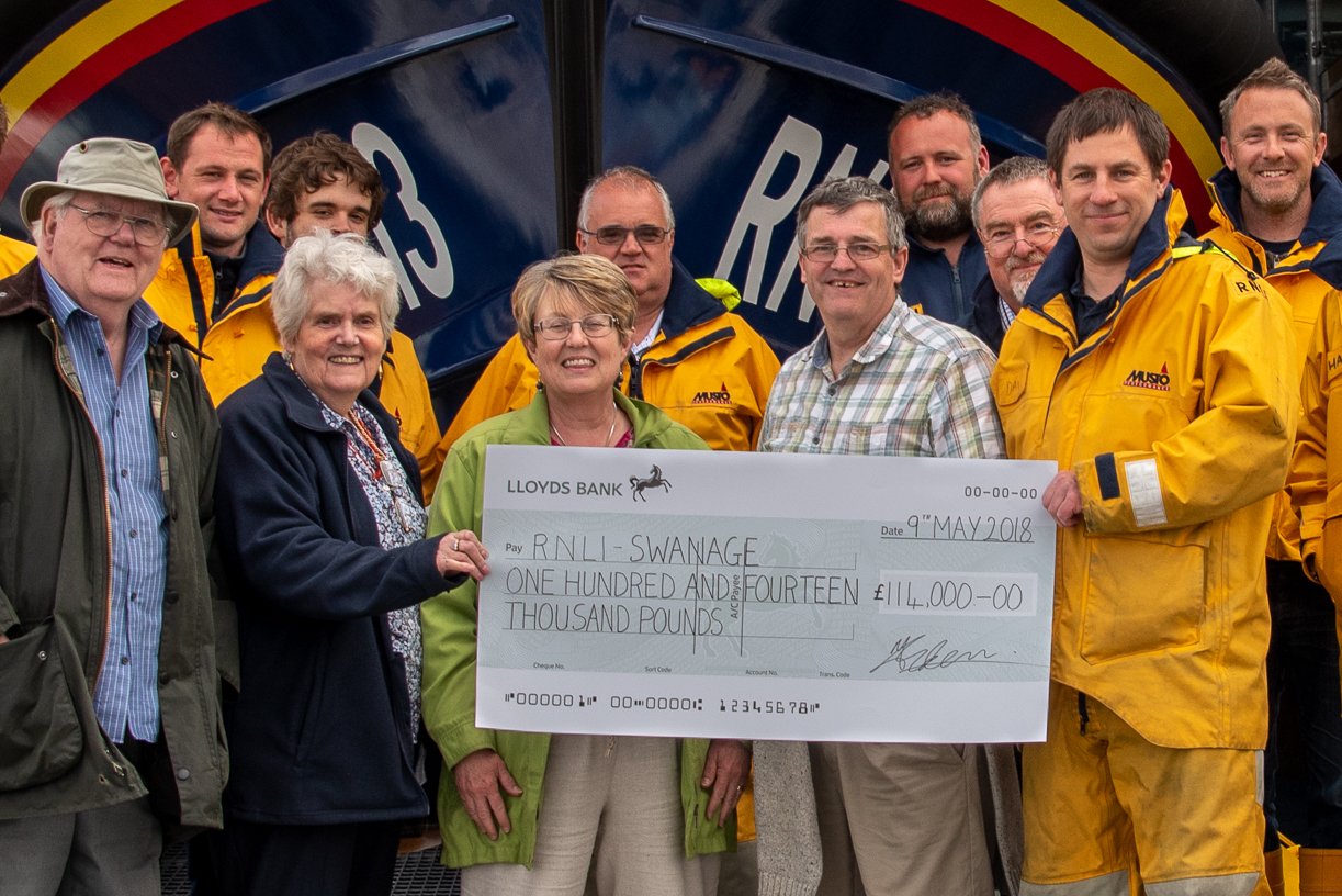Family of the late Bob Campbell present cheque to Swanage Lifeboat Station