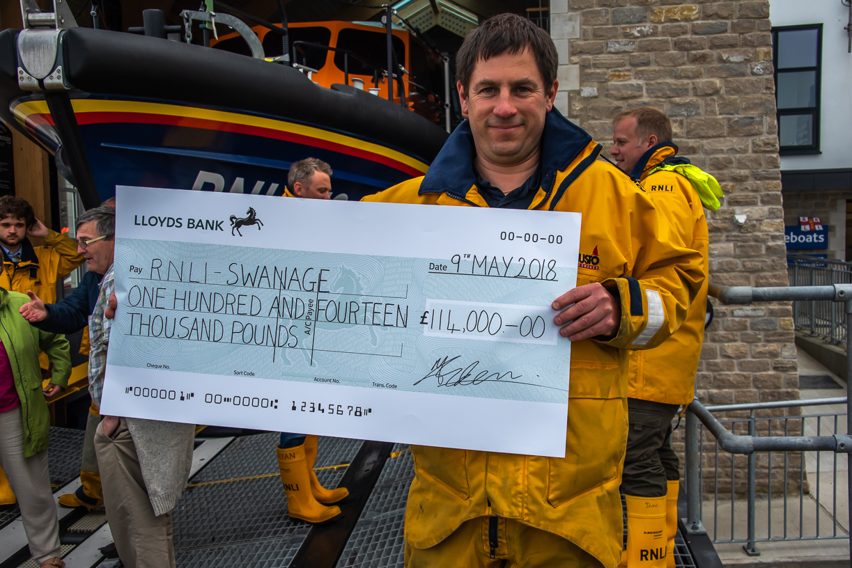 Coxswain Dave Turnbull with cheque presented by family of the late Bob Campbell