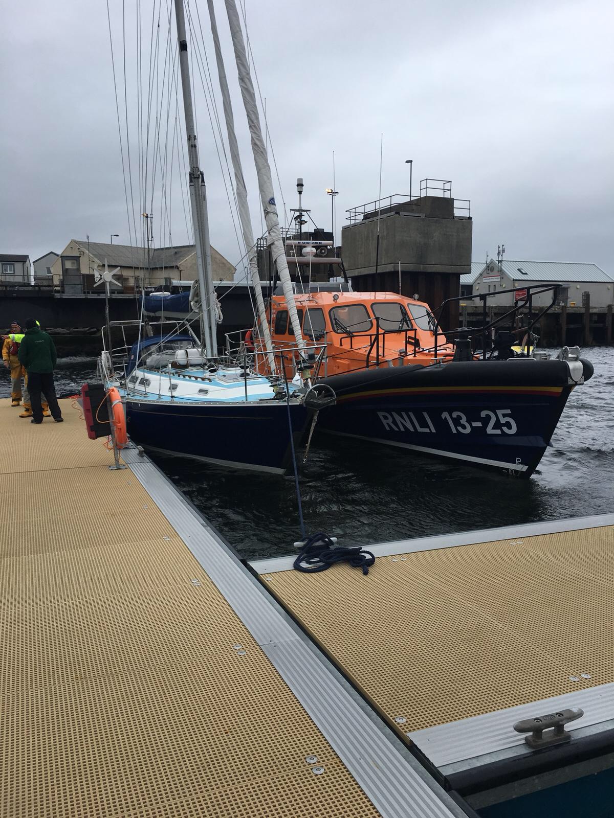 The 12m yacht, which had the injured female on board, safely alongside in Lochmaddy, with Leverburgh Lifeboat beside her.