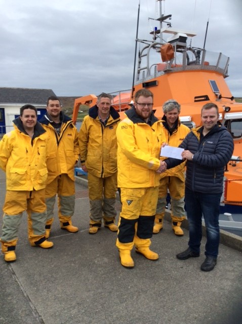 Captain Marius Joensen presenting cheque to John Robertson, looking on are crew members Allan Willmore, Chris Smith, David Nicolson, Luke Bullough.
