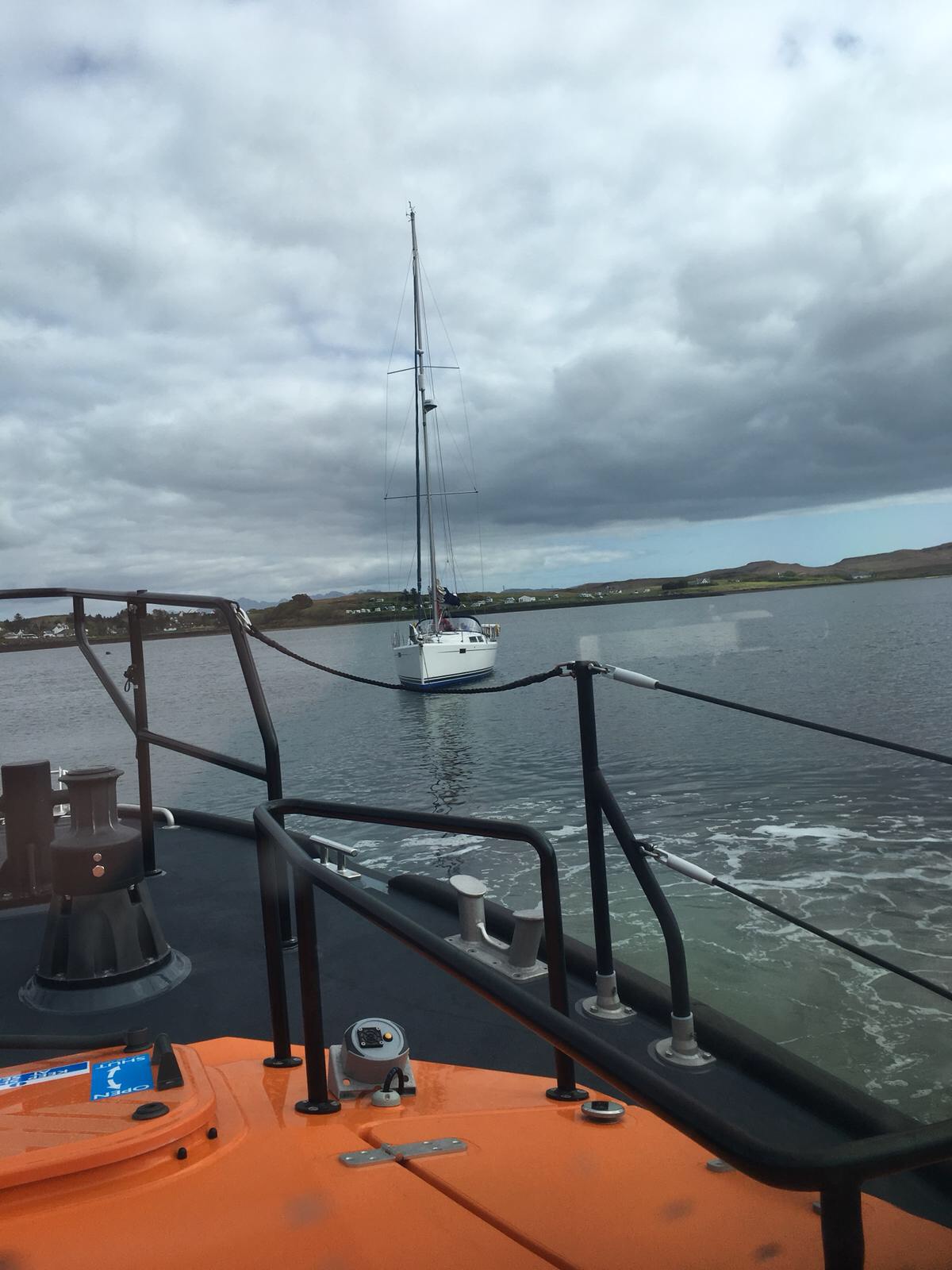 Bow of Shannon Class Lifeboat with yacht in distance