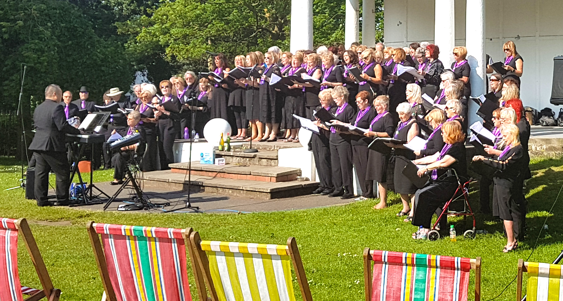 More than 100 SingMe Merseyside choir members performing in the bandstand at Vale Park to raise funds for RNLI New Brighton lifeboat station