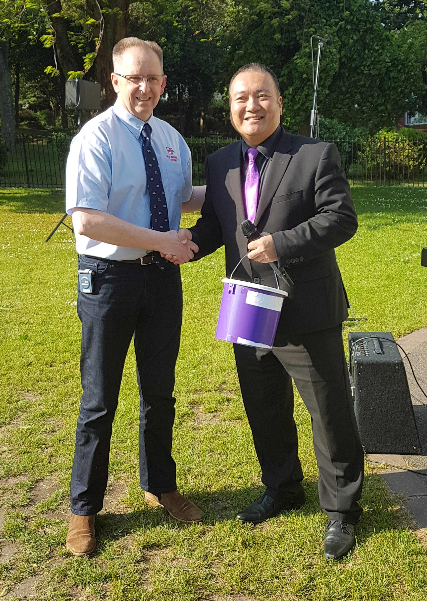 RNLI New Brighton's Deptuty Launching Authority Damian Cull with SingMe Merseyside Founder and Musical Director Billy Hui and a choir collection bucket