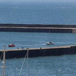 St Bees lifeboat towing the yacht into the safety of Whitehaven Harbour. 