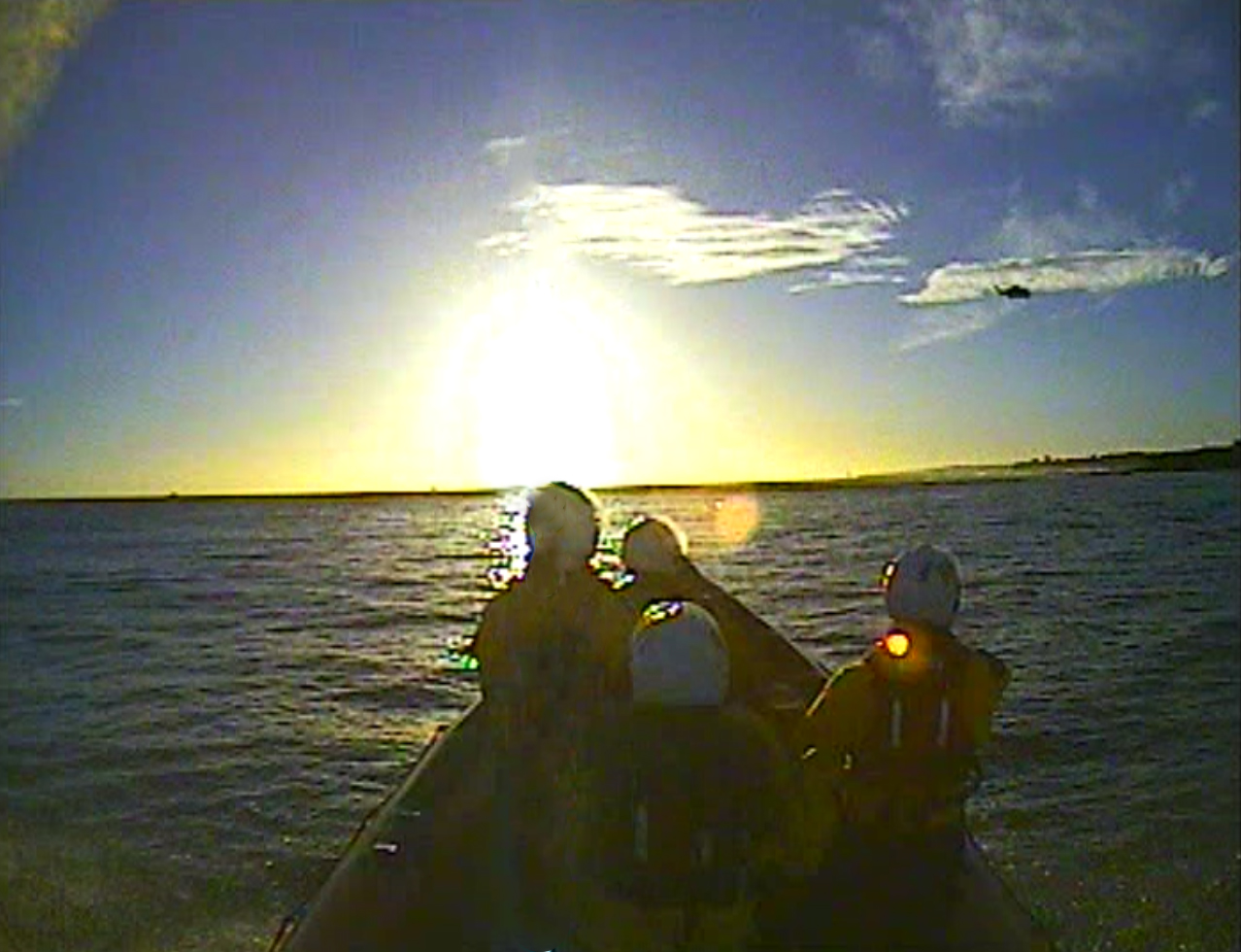 Cullercoats RNLI B class Atlantic 85 lifeboat during the search. with Coastguard Rescue Helicopter 912 visible in the distance.