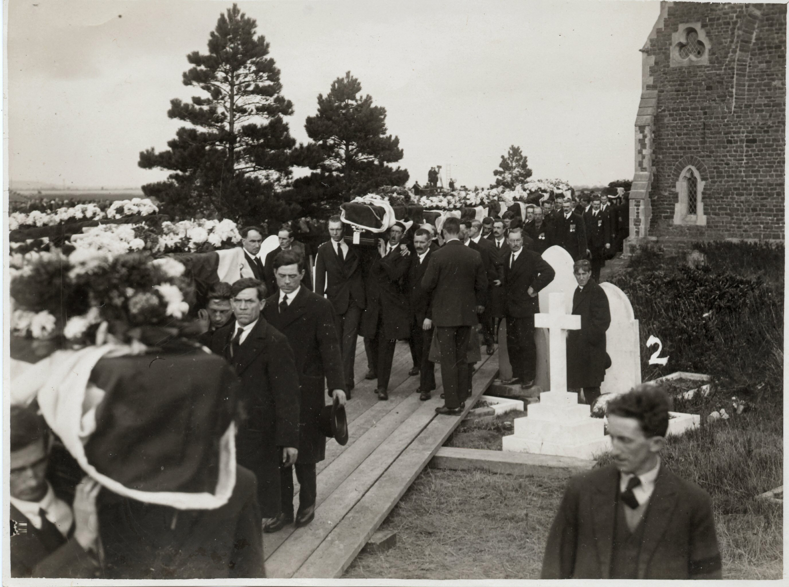 coffins carried aloft through the village