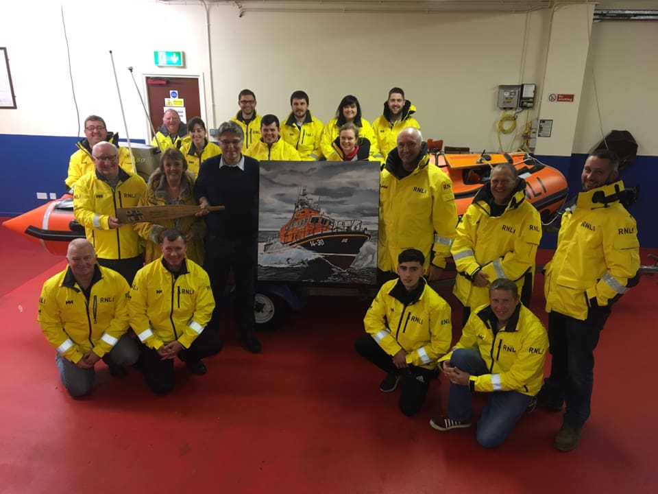 Geoff Johnston presents his painting to Larne RNLI coxswain, Frank Healey