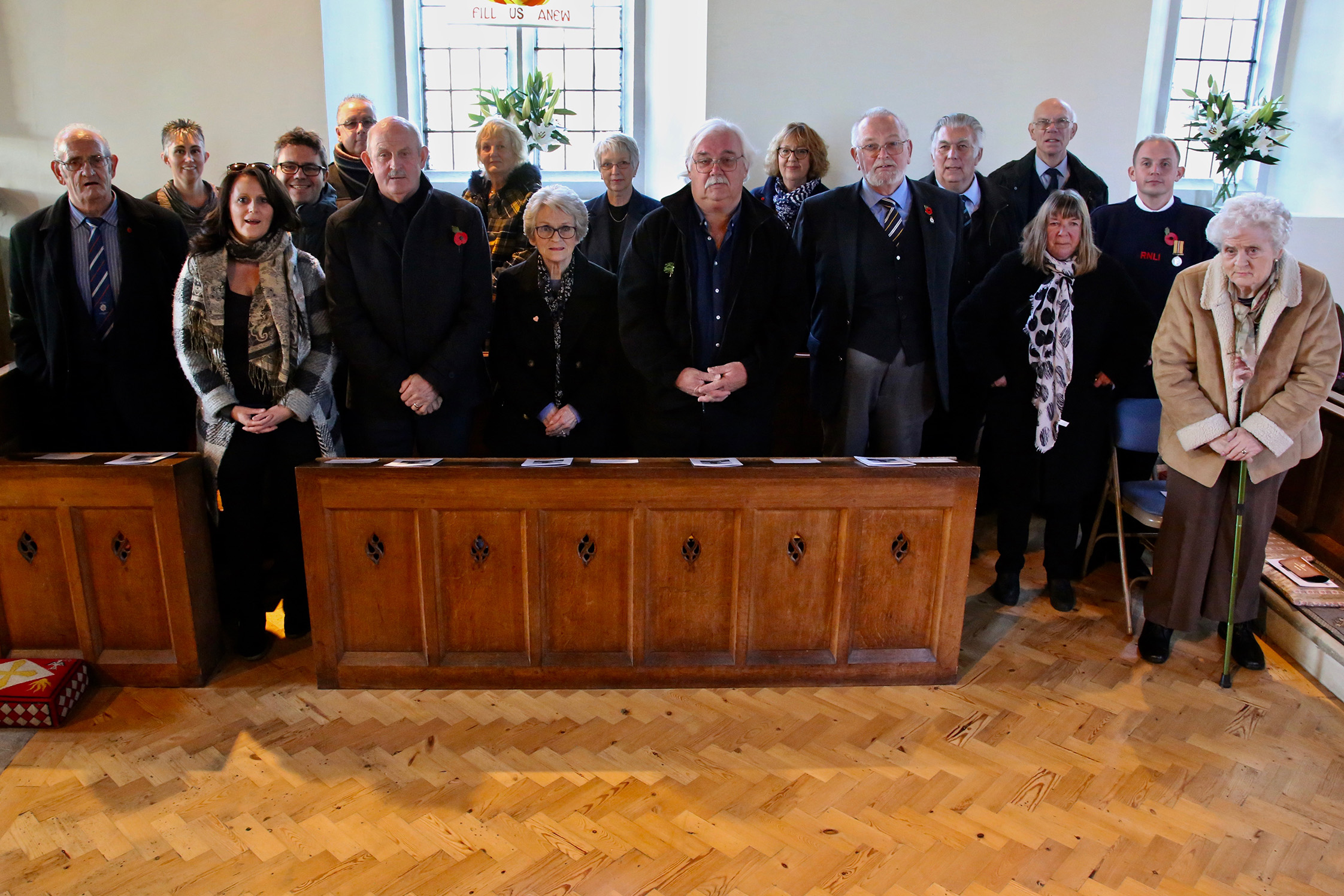 A gathering of seventeen descendants of the men who died in the Mary Stanford disaster standing in Rye Harbour church