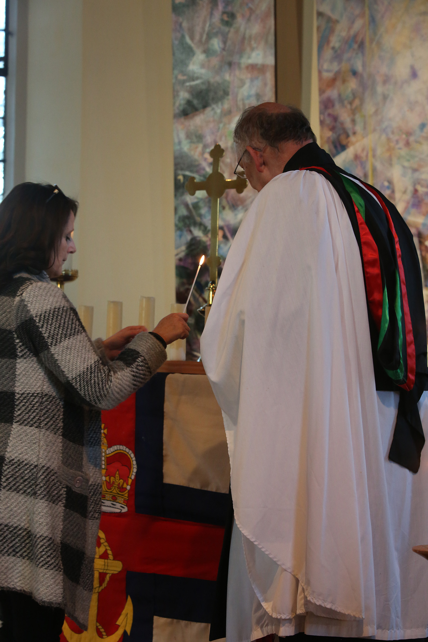 Sarah Reader, great niece of William Clark, stands in front of the altar and lights a candle in his memory