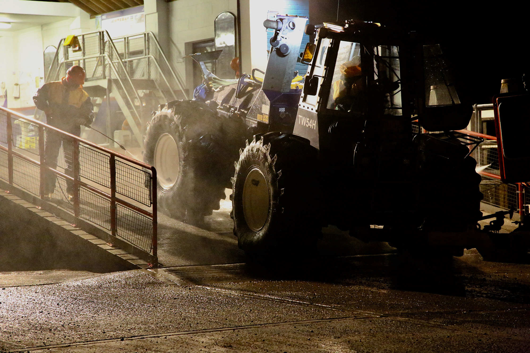 The lifeboat launch tractor is hosed down as it ascends the ramp into the lifeboat station