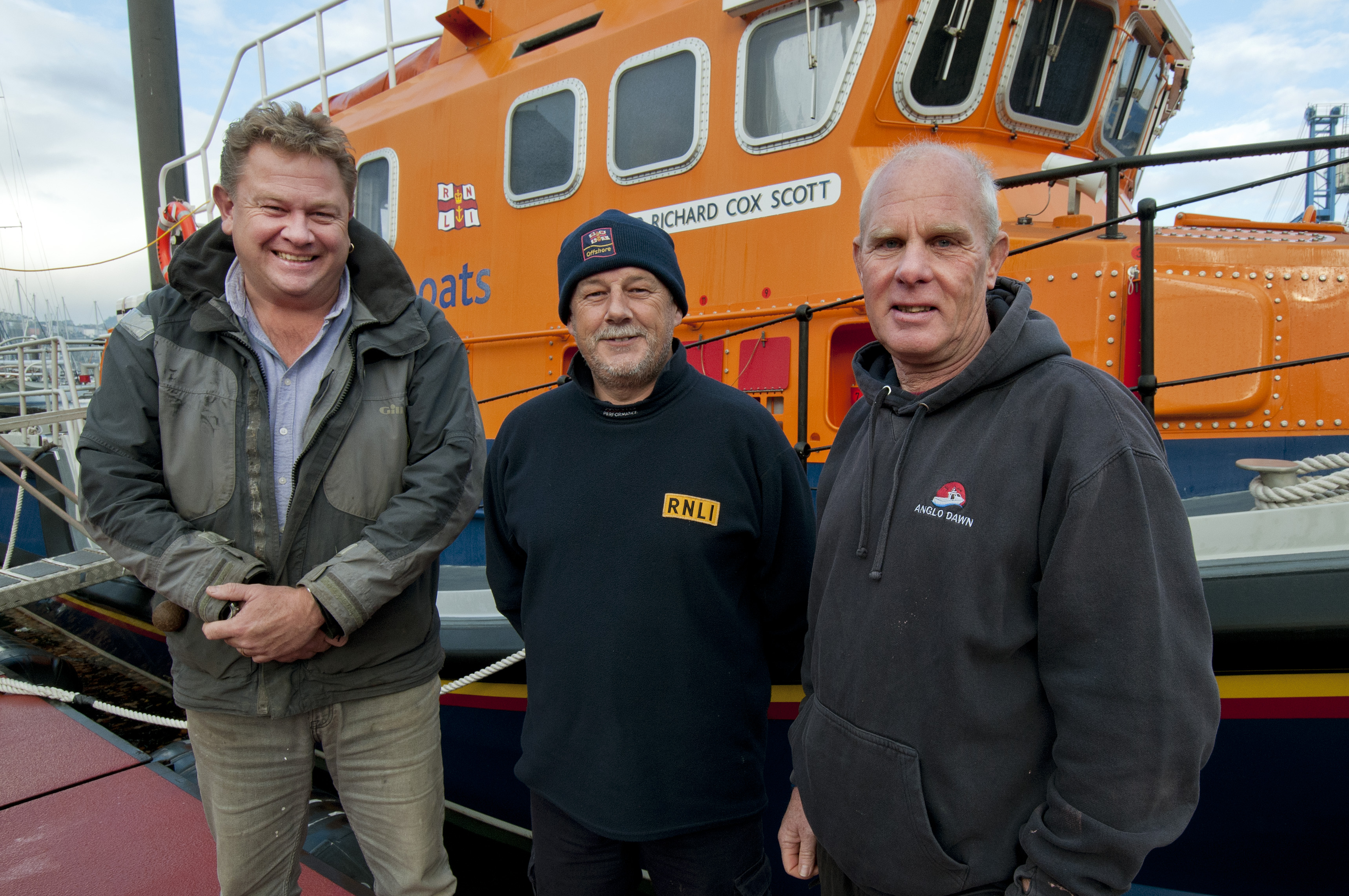 Falmouth RNLI Coxswain Jonathon Blakeston with Nigel Hodge (left) and Andy Howell (right).
