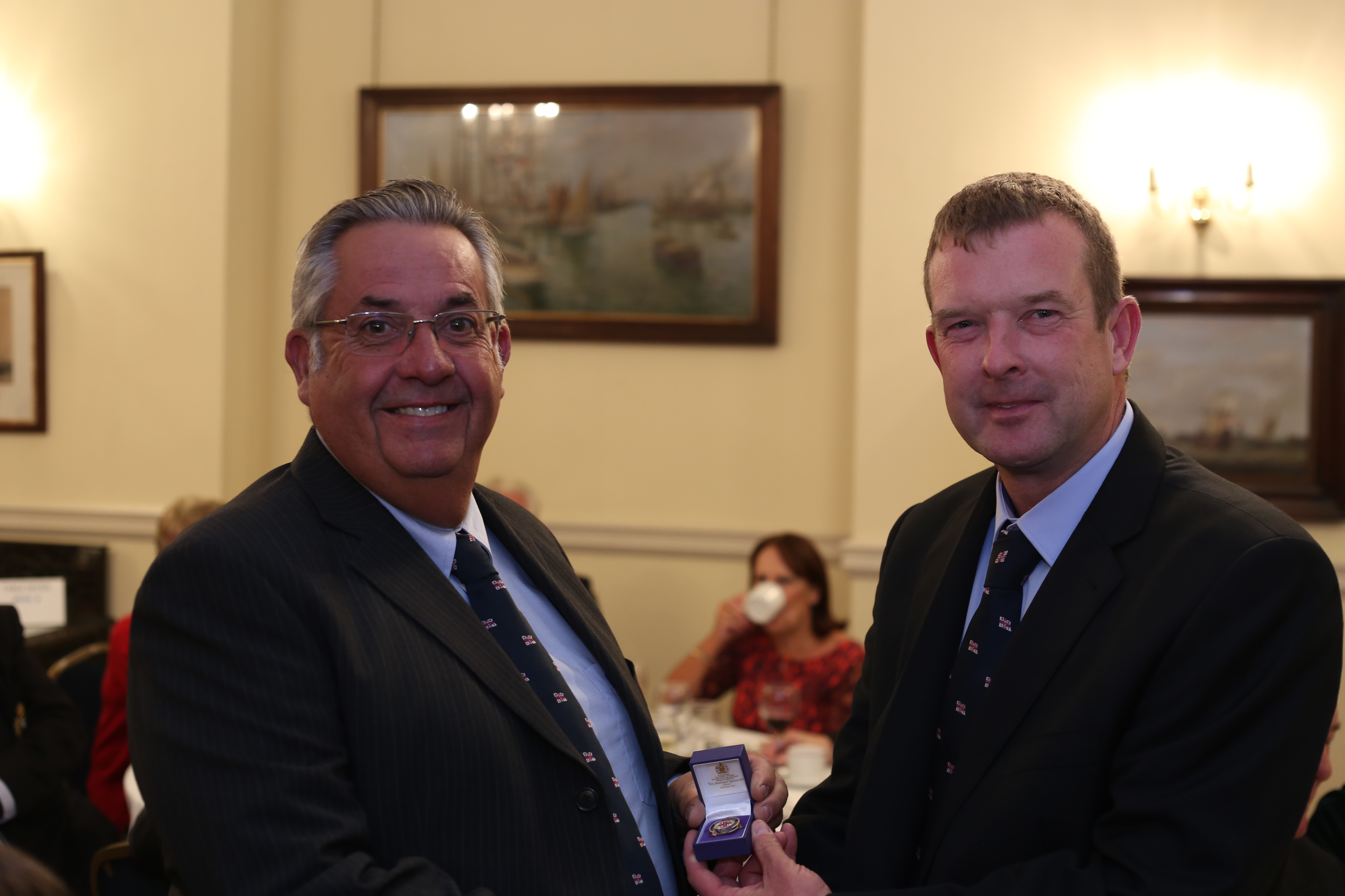 Picture of Clive Nicholls being presented with his medal by Coxswain Ian Cannon (left).