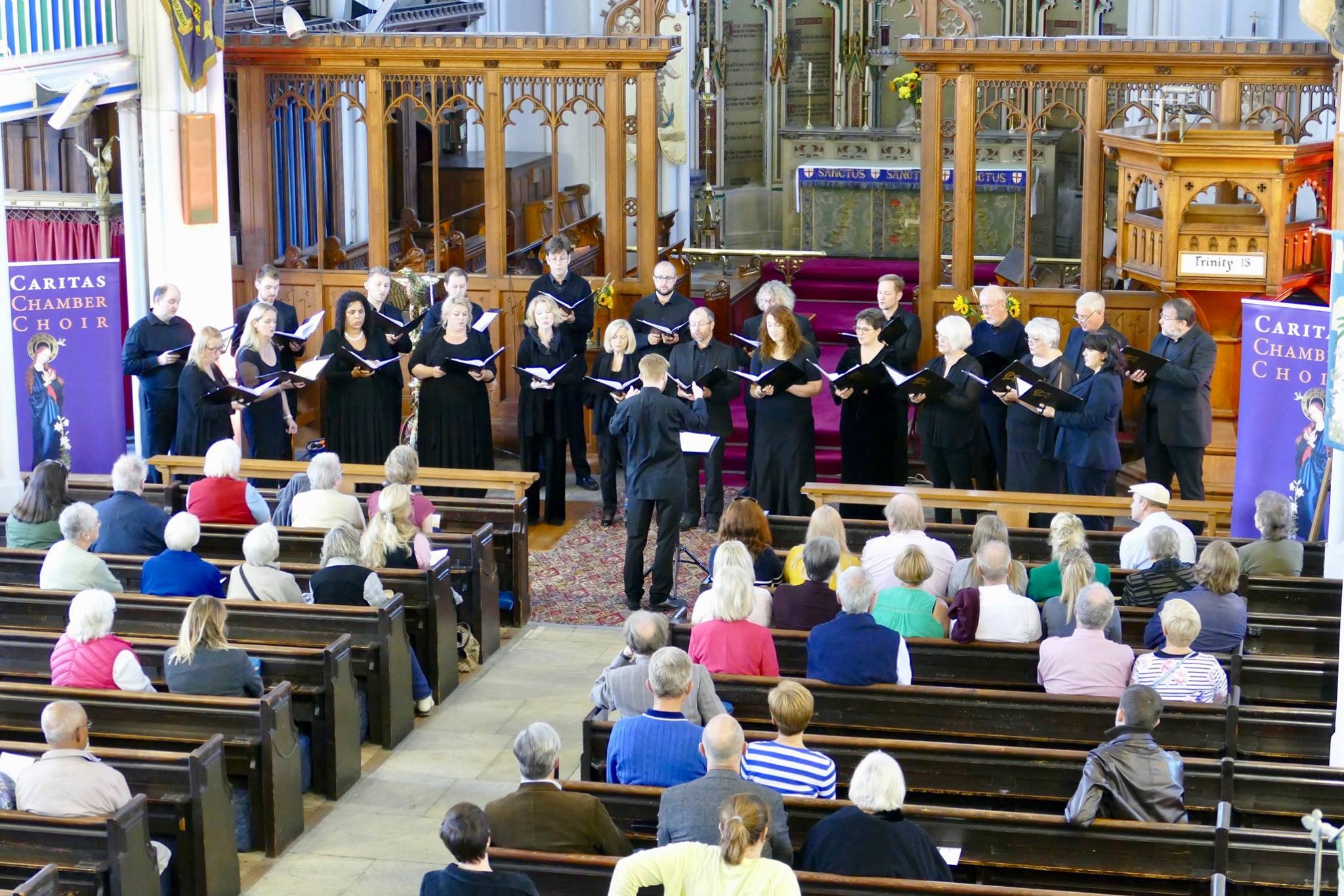 Photo of the Caritas choir performing at the church.