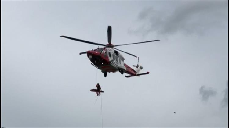 Logan being winched into the Coastguard helicopter