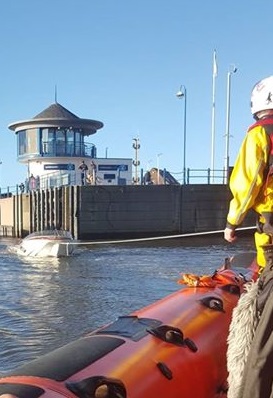 Towing the speedboat through the lock gates