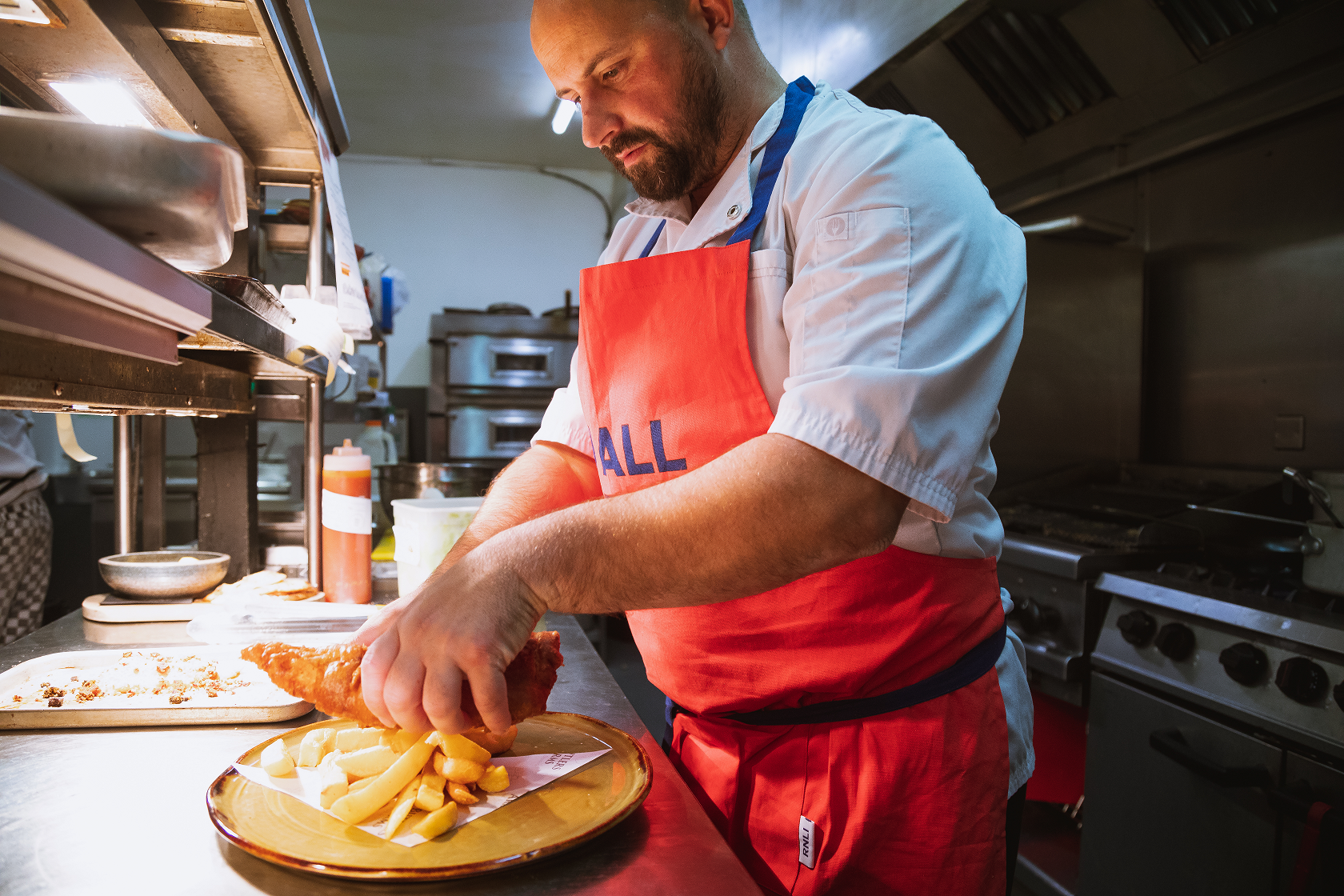 Michael Hales is in the kitchen of his restaurant serving up fish and chips to the pass