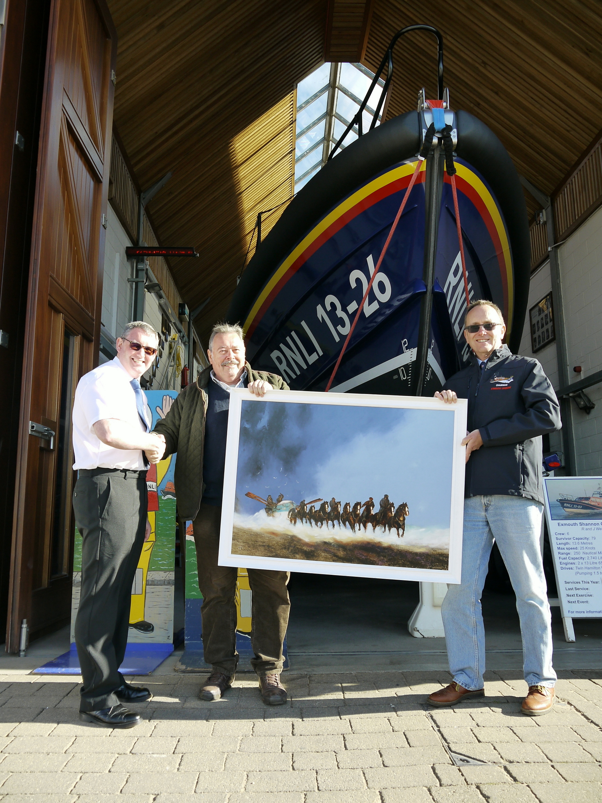 David Chambers (centre) hands over his painting to Rory Carrig, Chair, Exmouth RNLI Fundraising Committee (left) and Simon Davidson, Chair of the Lifeboat Management Group (right).