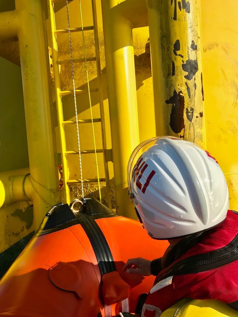 Crew up close to the wind turbine
