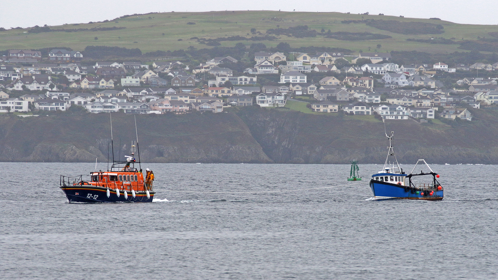 Douglas all-weather lifeboat Marine Engineer with casualty vessel entering Douglas harbour