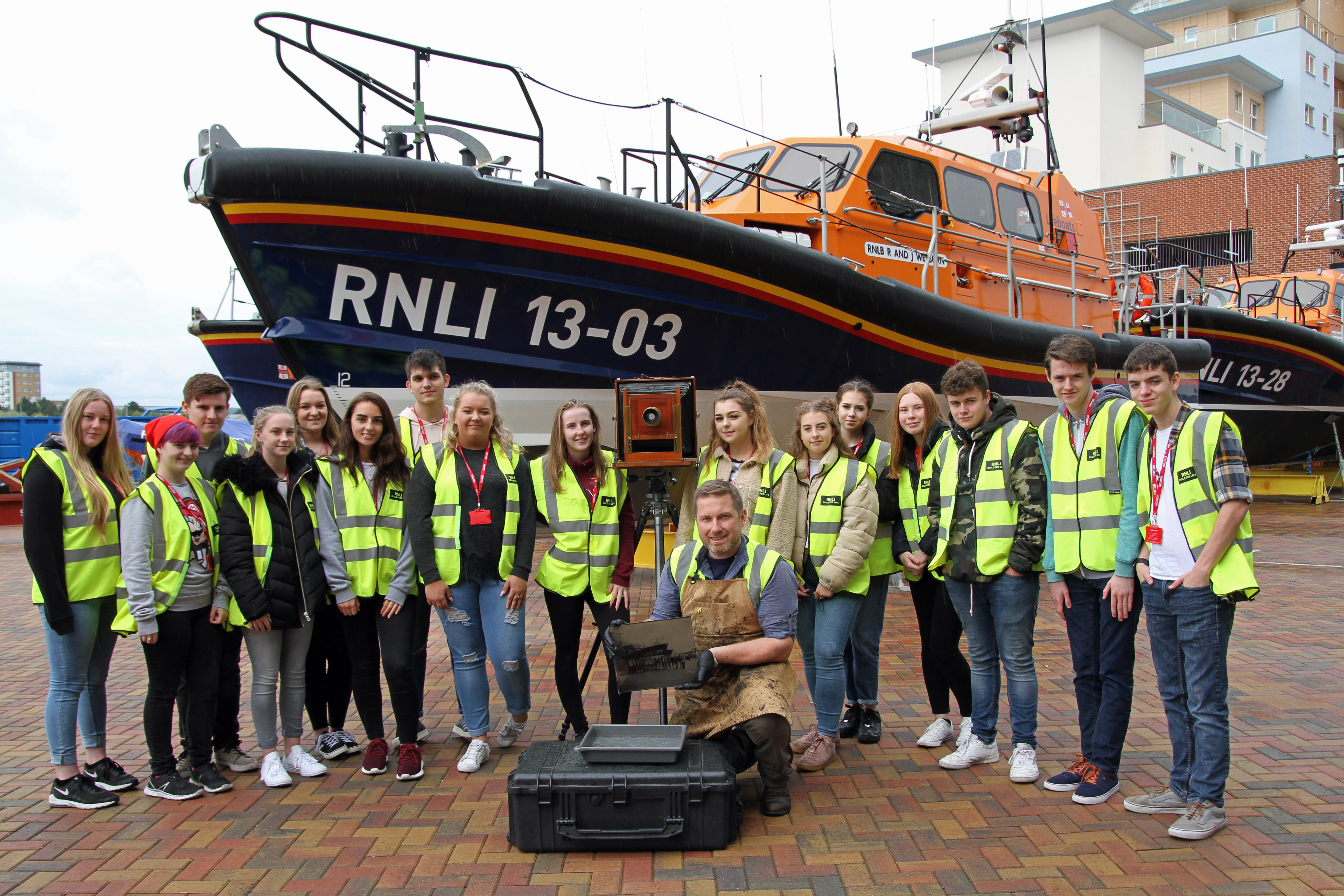 Jack Lowe and photography students from Poole High School at RNLI. Jack holding glass plate.