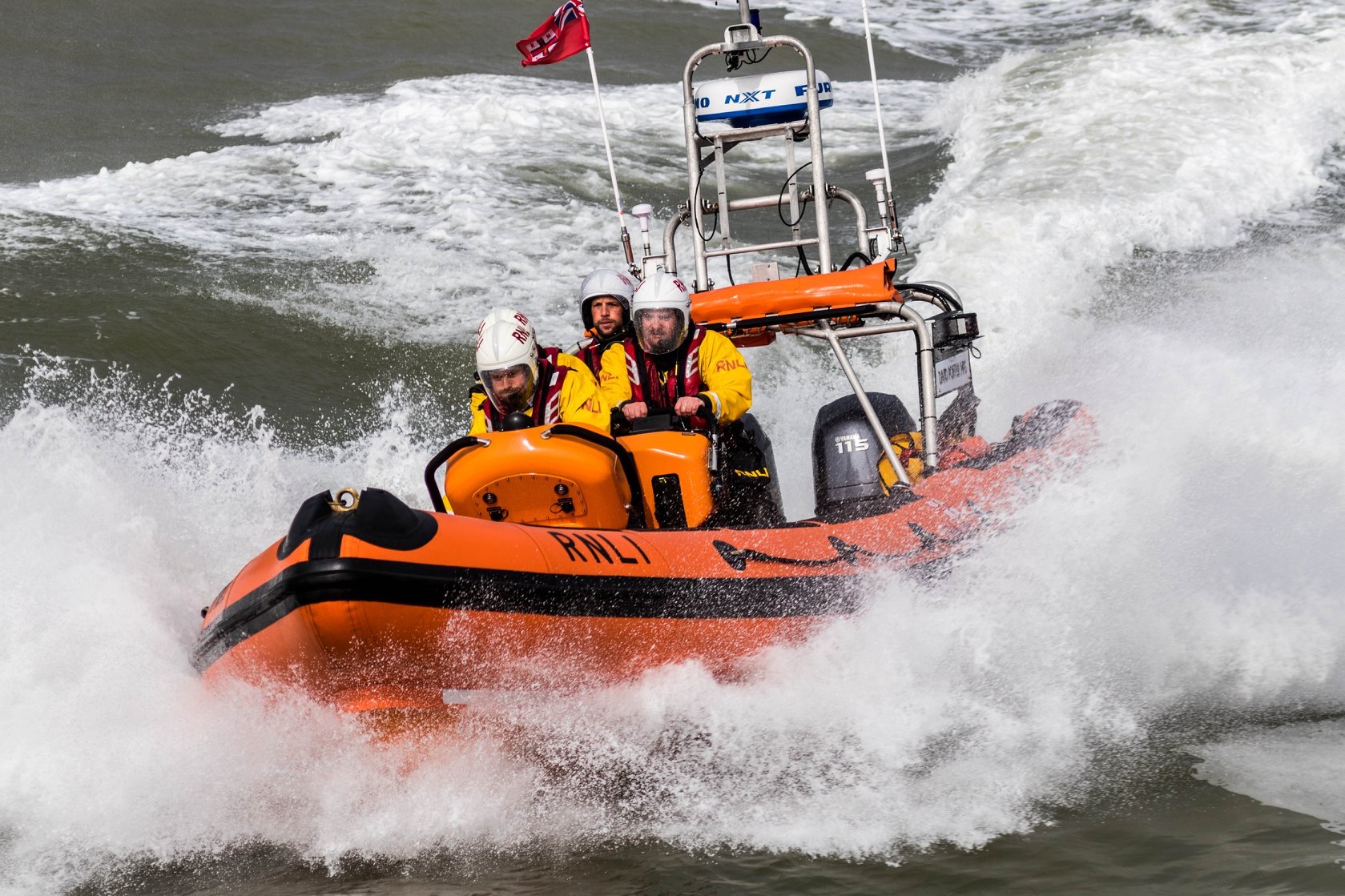 Photo of Clacton RNLI’s Atlantic class lifeboat coming towards camera with 3 crew aboard
