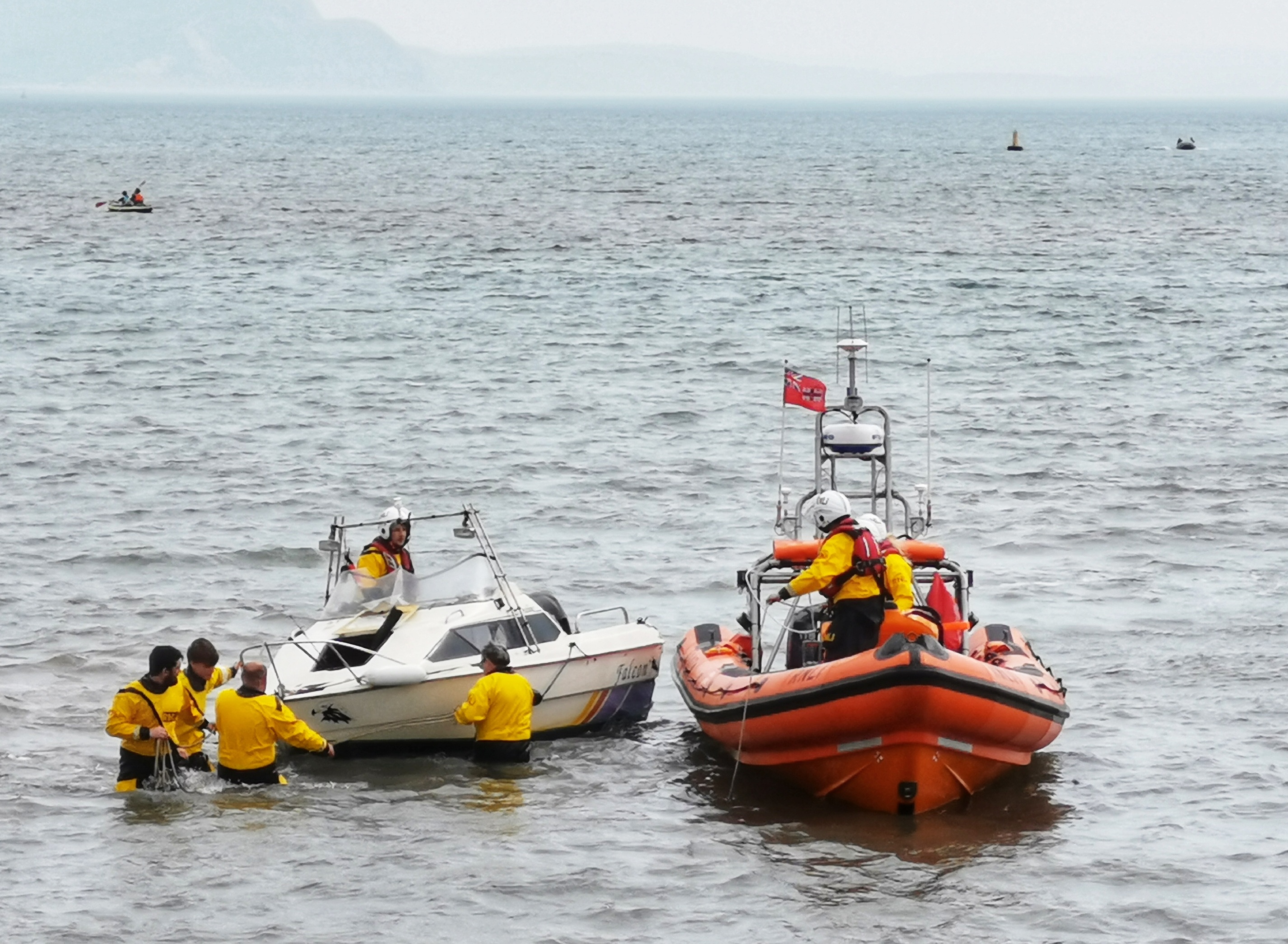 Volunteer shore crew receiving the damaged boat from the lifeboat crew