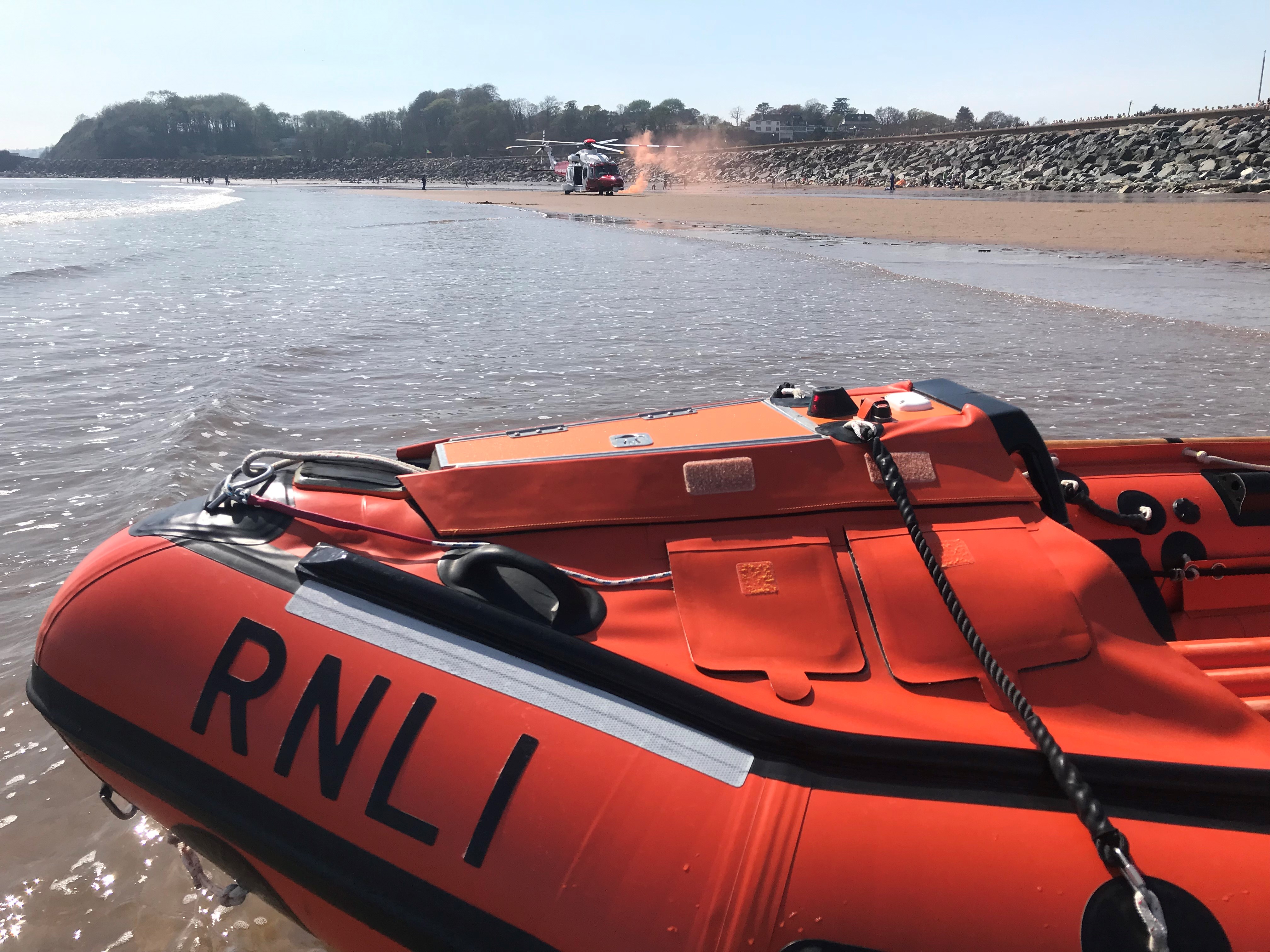 D class lifeboat George Bearman II and Coastguard Rescue 187 helicopter on Dawlish Warren beach
