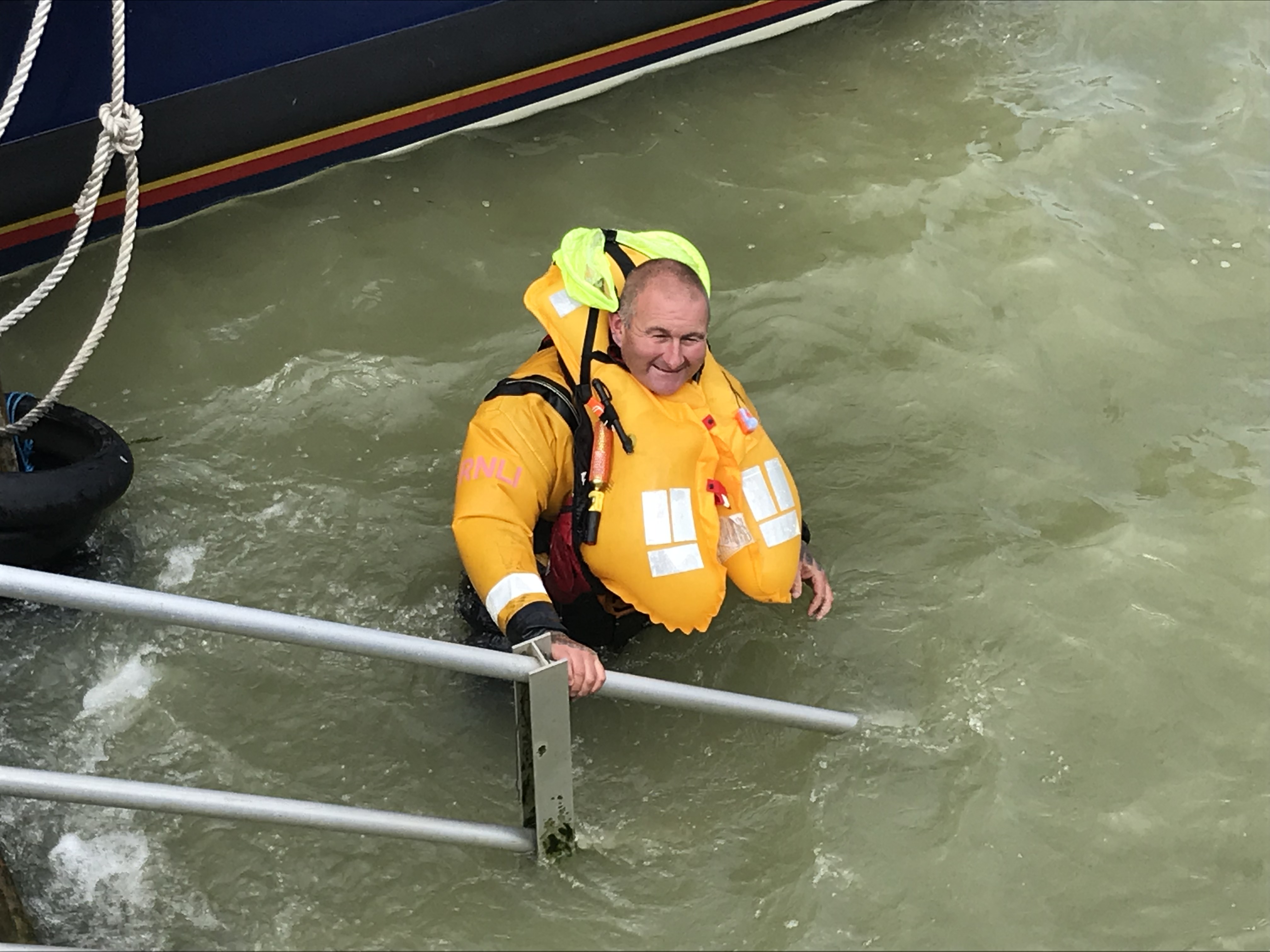 image of a crew member with an infated lifejacket.