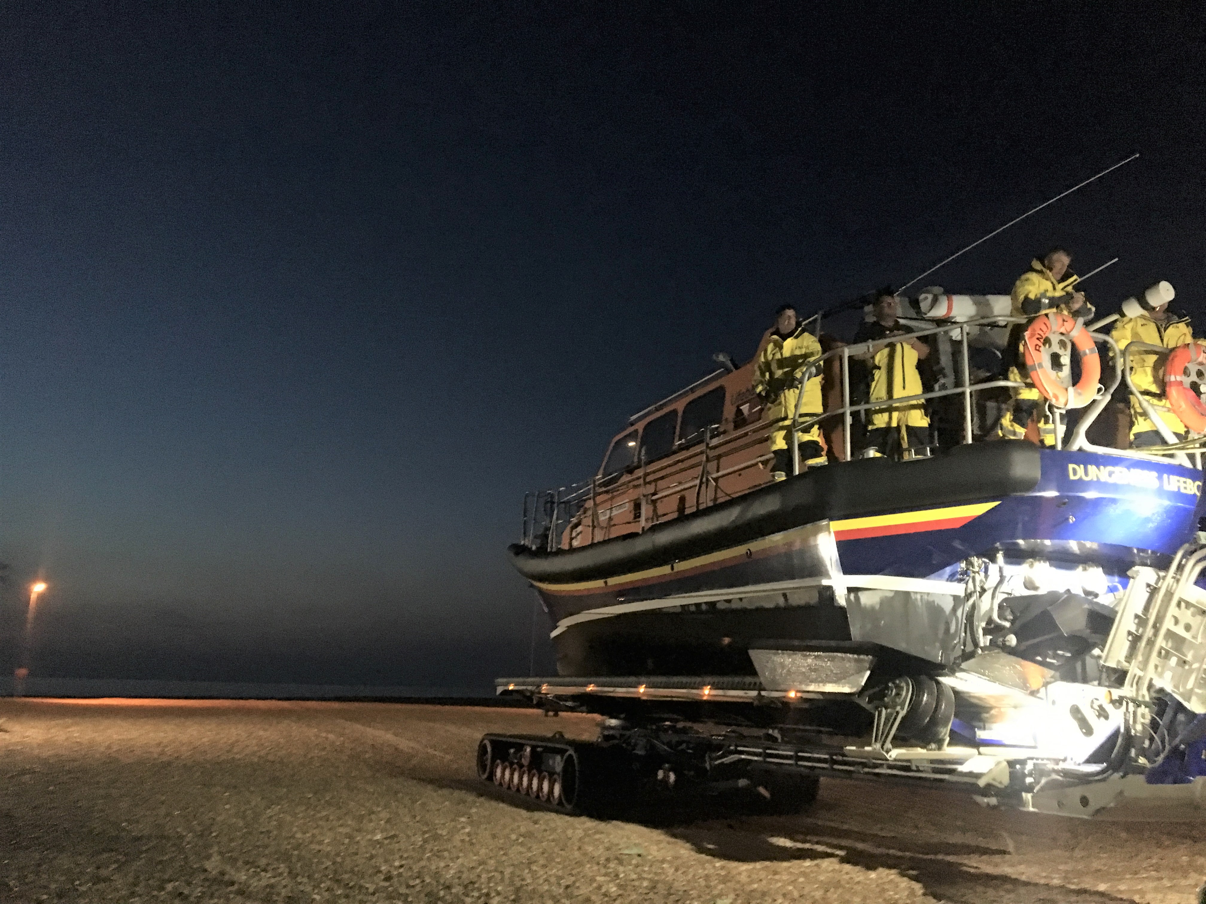 Crew members on board the lifeboat on the SLARS trailer at night