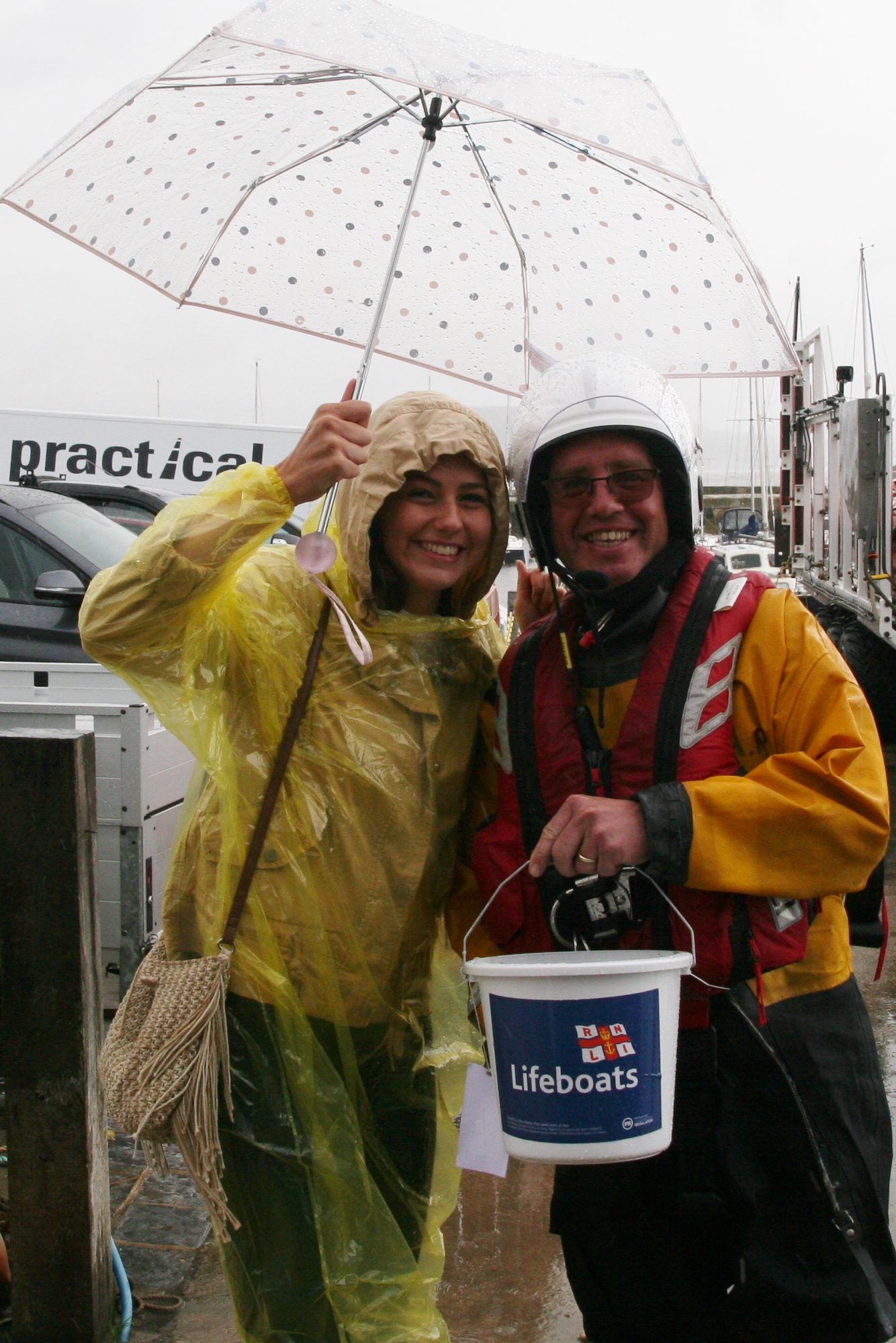 Lyme Regis crew member Dave Holland gets help to shelter from the rain.