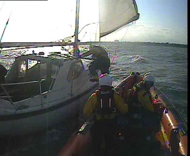 Crew member scrambling aboard casualty yacht