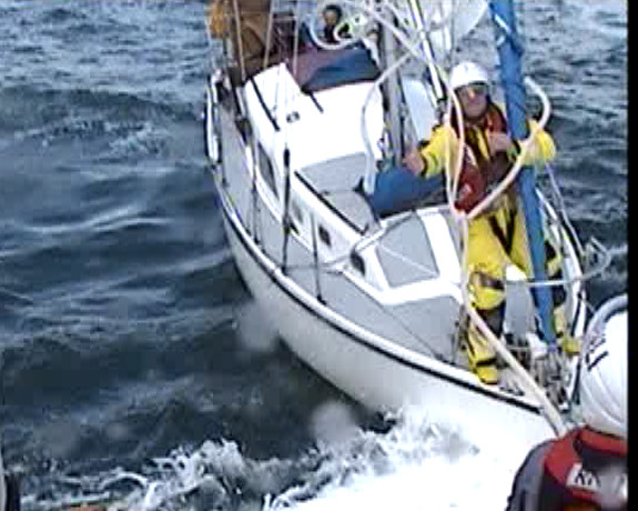 A towline is thrown to a lifeboat crew member on the yacht