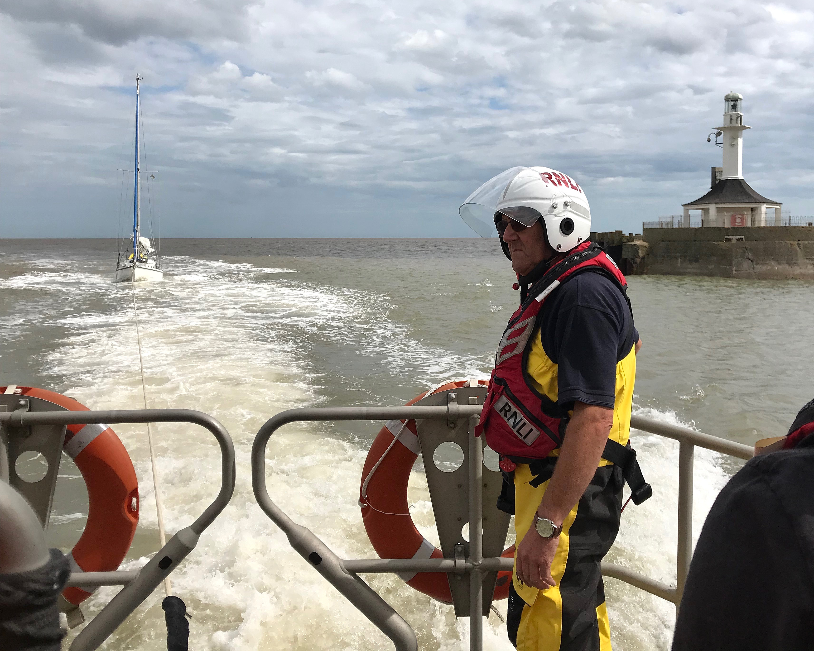 Lowestoft RNLI LIfeboat 'Patsy Knight' brings the yacht with the exhausted sailor into port
