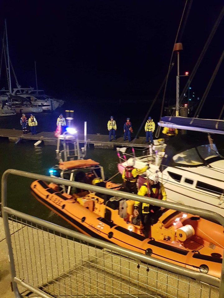 Poole Lifeboat volunteers safely mooring the recovered vessel 