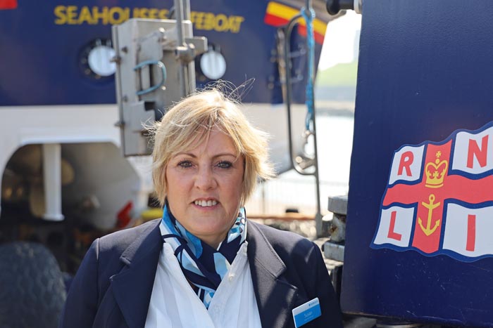 Susan in work uniform beside the Talus Tractor