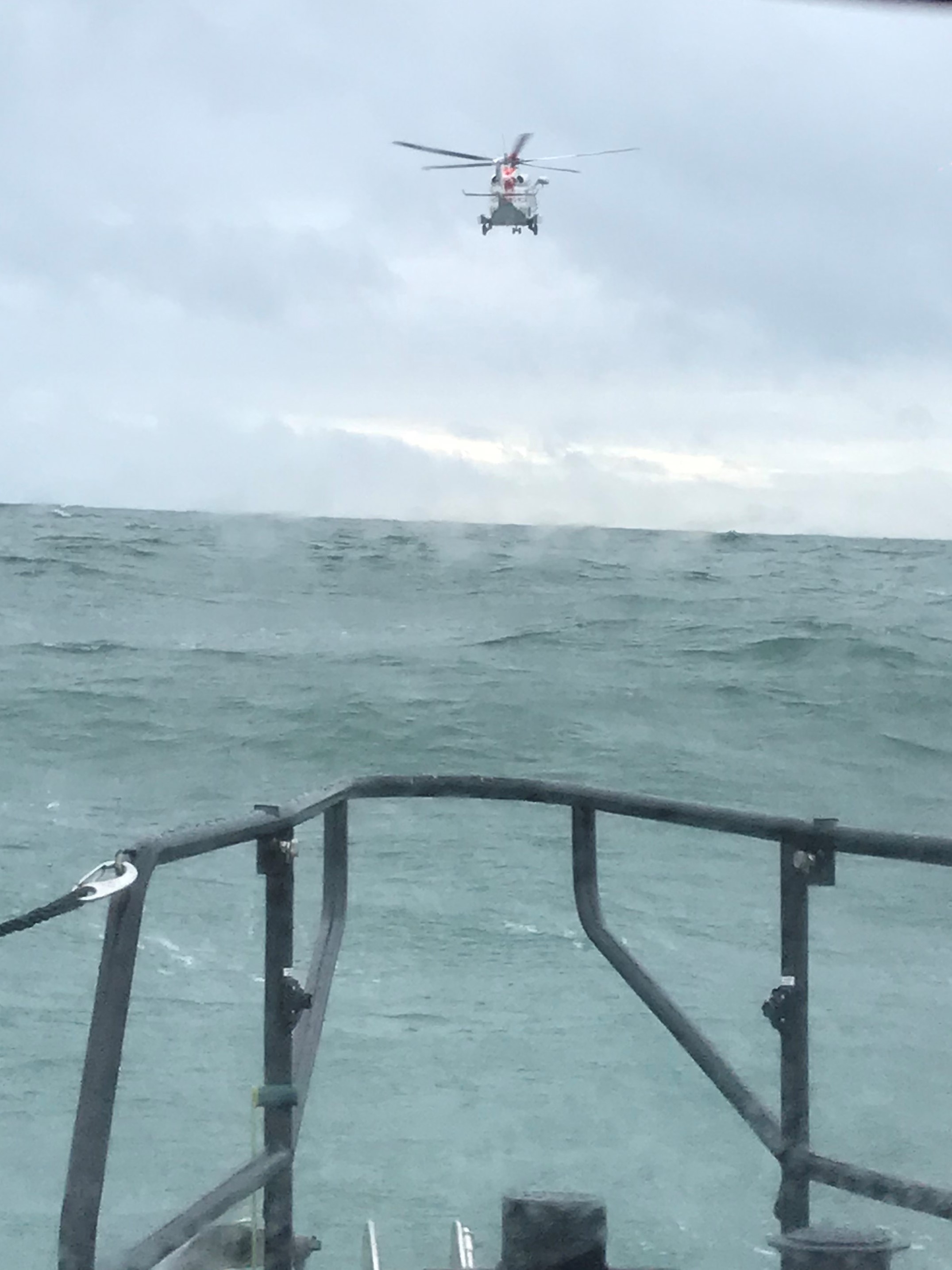 Coastguard helicopter leaving seen from stern of lifeboat