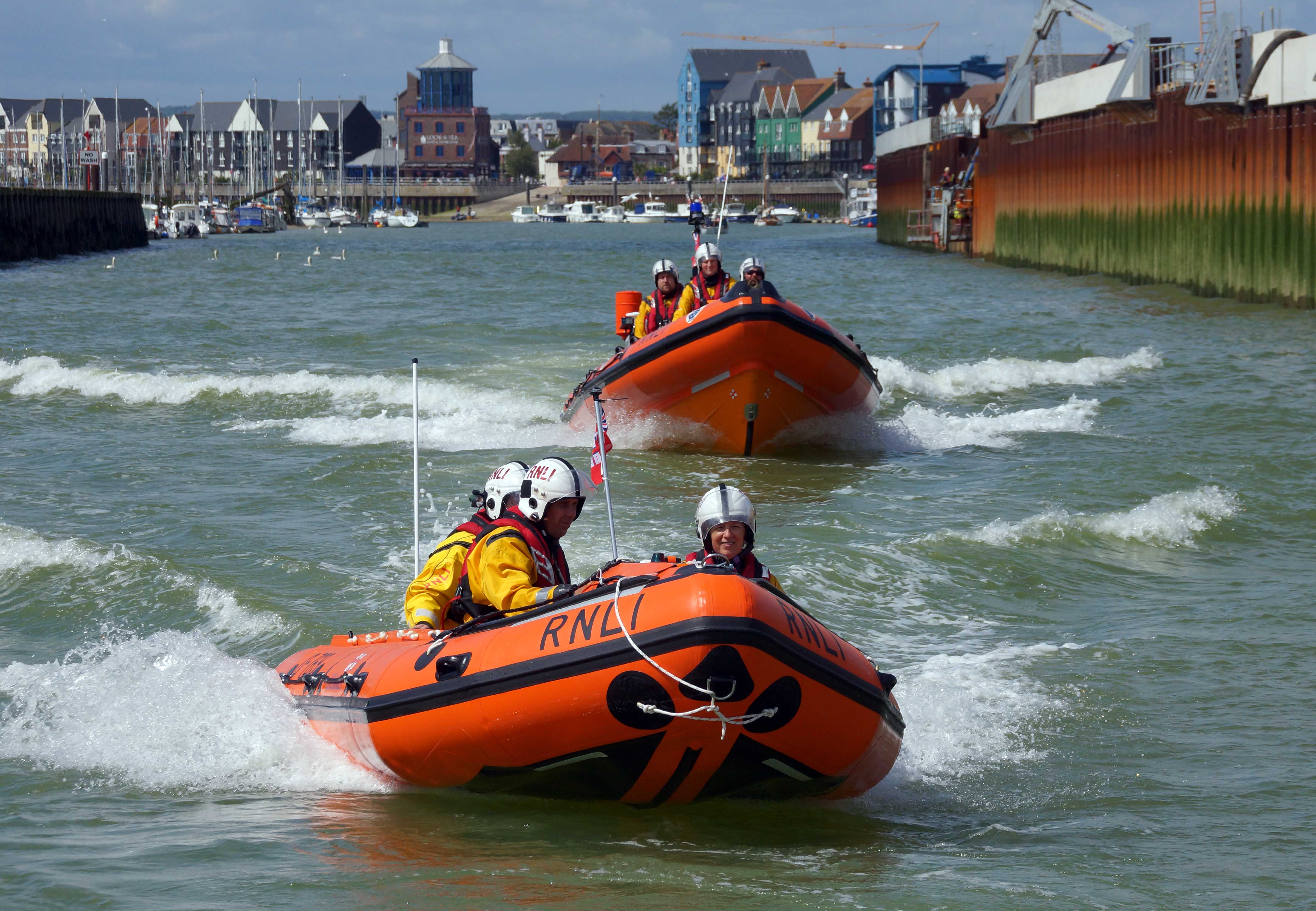 Photo of the two Littlehampton Lifeboats heading out from the harbour.