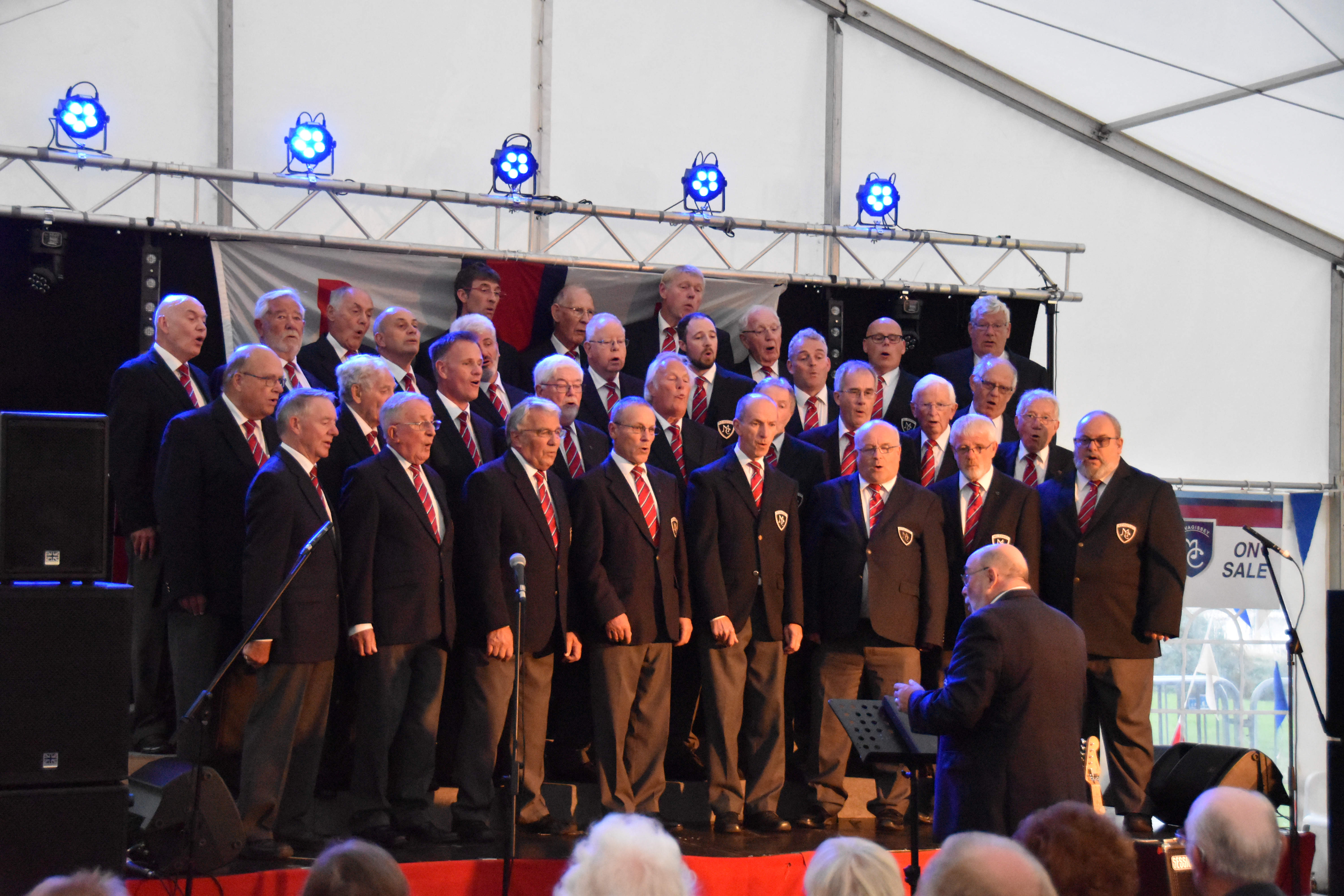 Mevagissey Male Choir singing on the stage in the Lifeboat marquee during Lifeboat Weekend