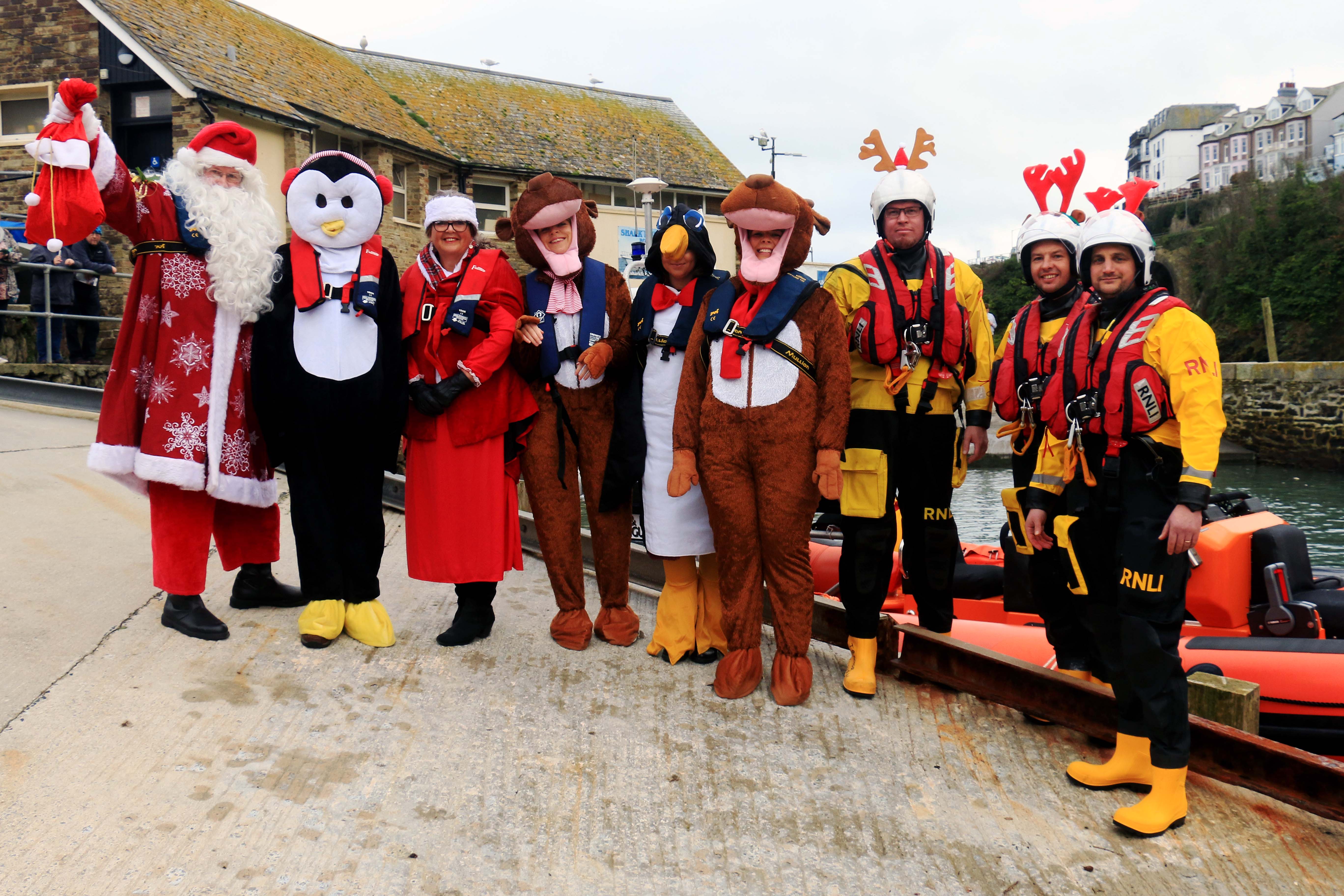 Santa and his helpers with Looe RNLI volunteer crew, Alastair Pearn, Dan Margetts and Toby Bray at Looe Lifeboat Station