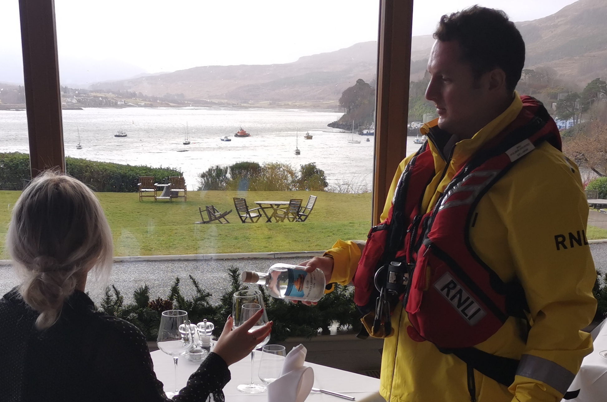 Lifeboat Crewman Will serving drinks at the Cuillin Hills Hotel overlooking Portree Lifeboat in the Harbour.