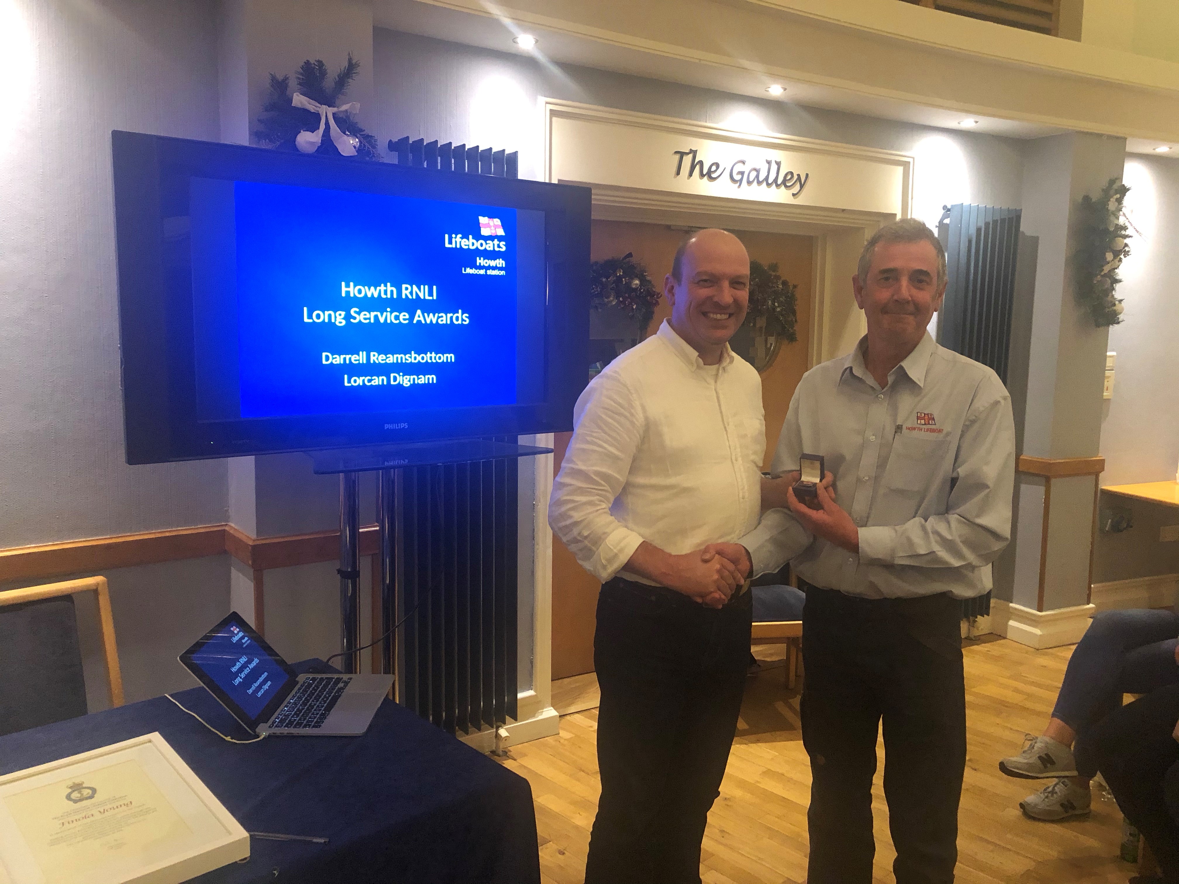 Photo attached shows Howth RNLI volunteer lifeboat crewmember Lorcan Dignam receiving his twenty year service award
