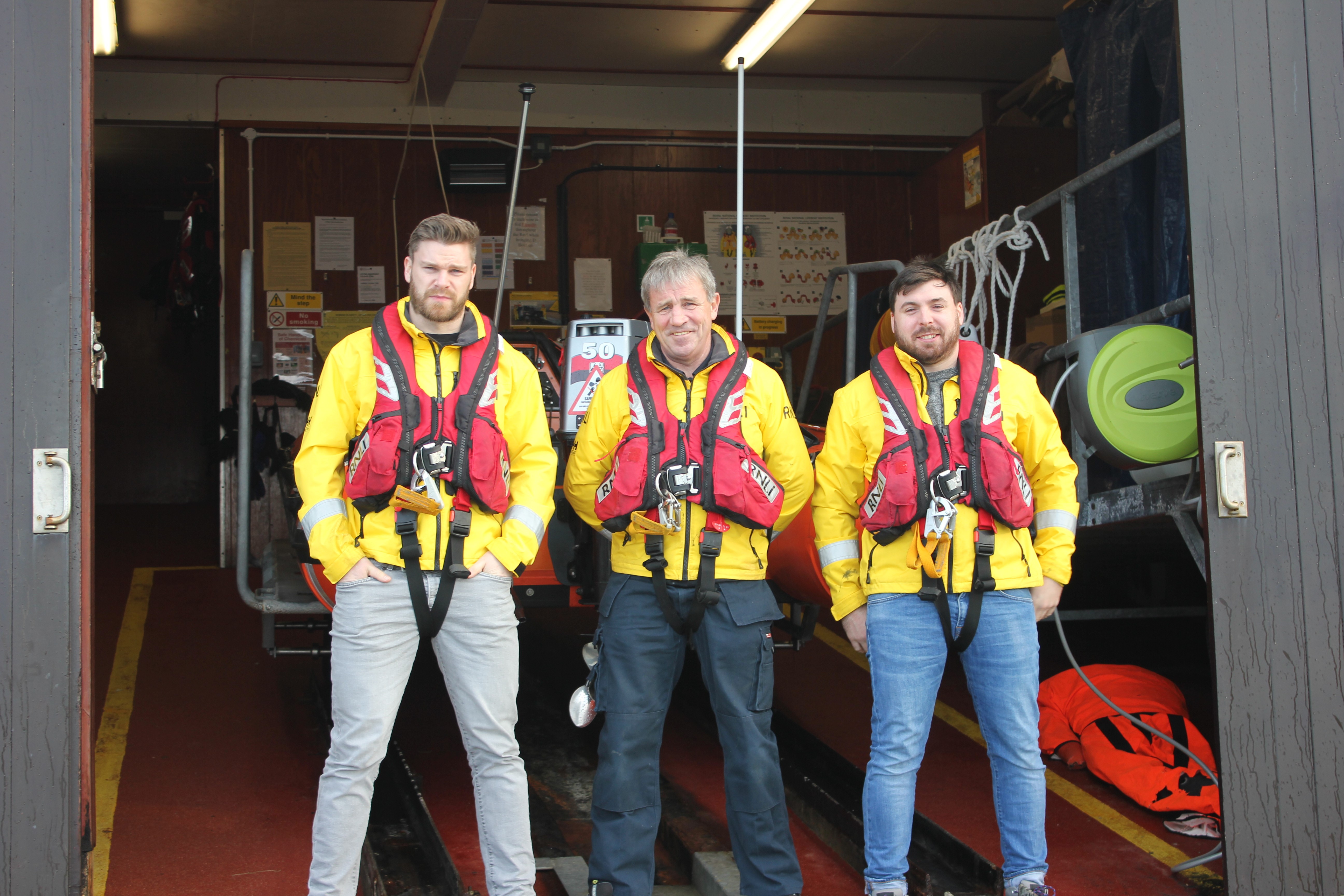 Lifeboat crewmember Karl O’Neill, Portrush RNLI station mechanic Anthony Chambers and volunteer crewmember Jason Chambers