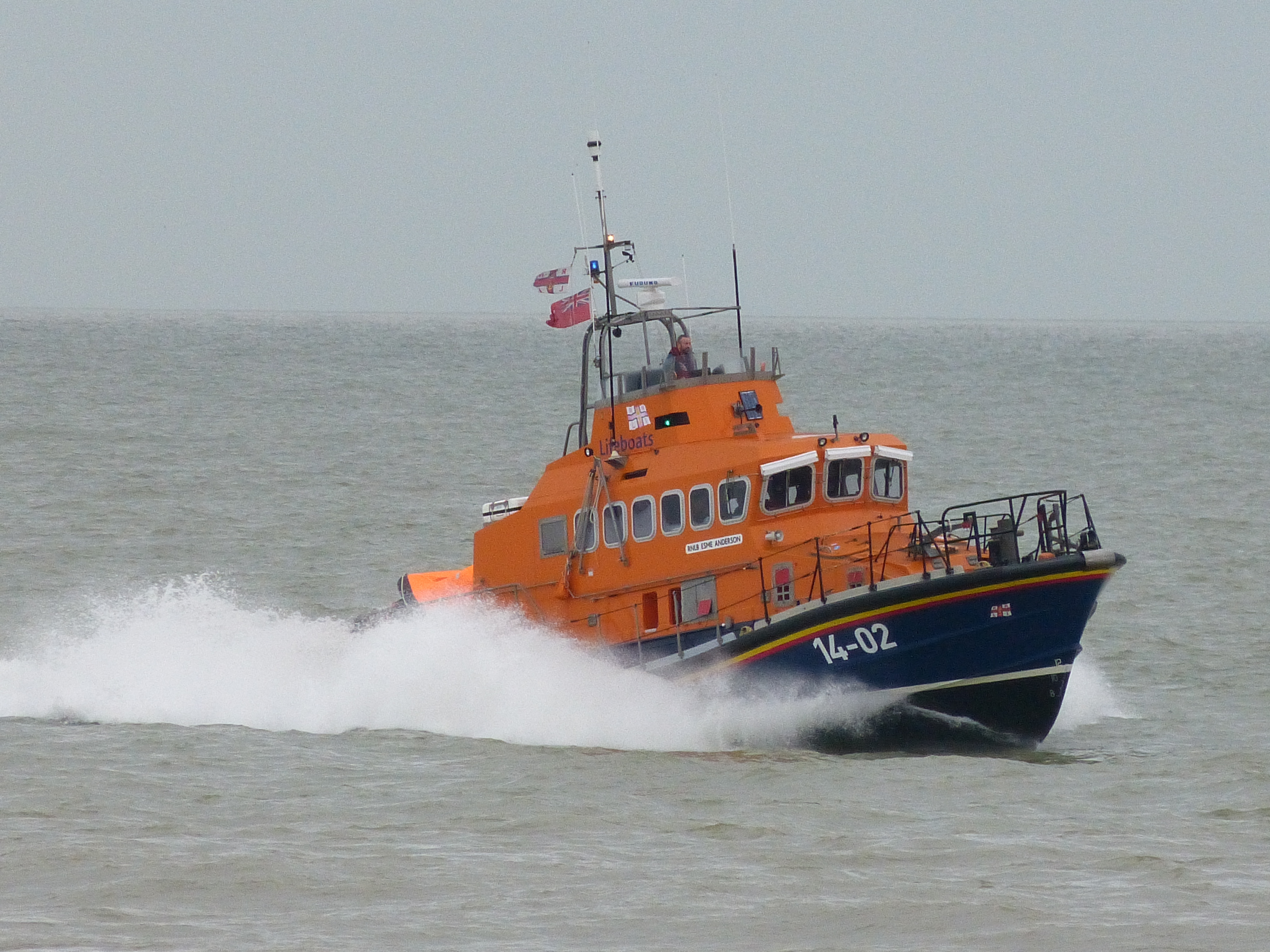 A lifeboat with a wake motoring.