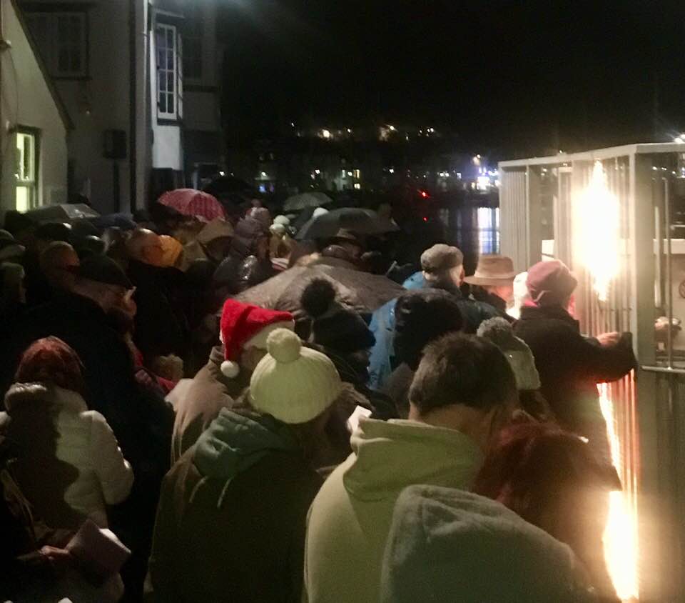 The crowd singing carols