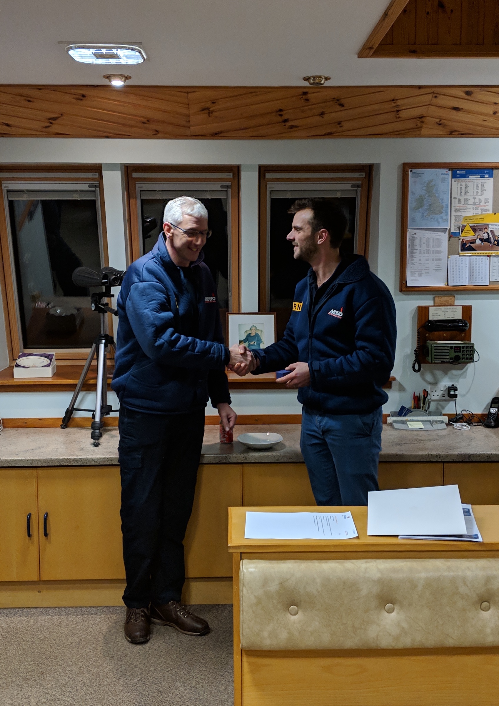 David Park standing shaking hands with Henry Weaver who has a Long Service Medal in his hand